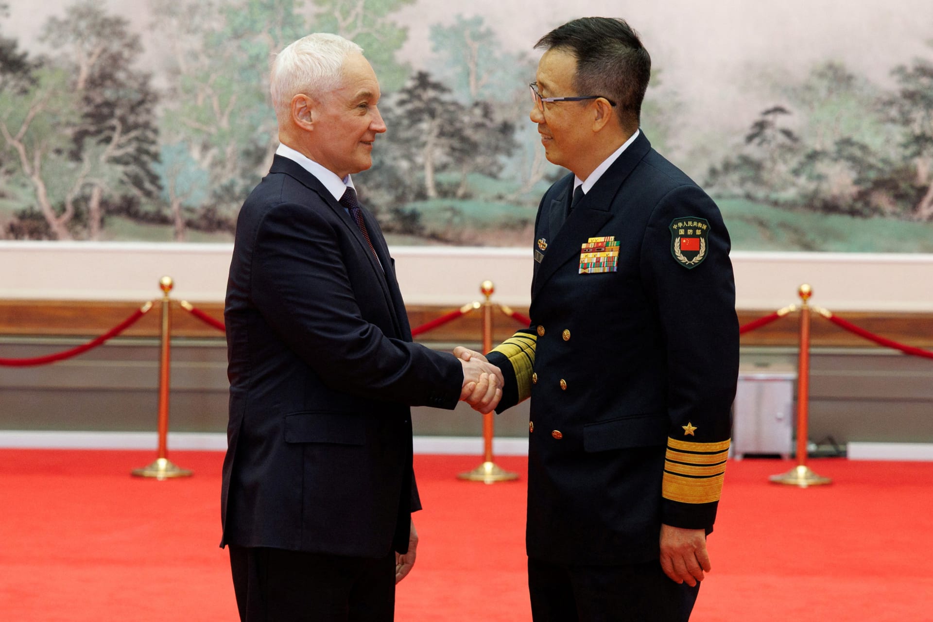 <p>Chinese Defense Minister Dong Jun shakes hand with Russian Defense Minister Andrei Belousov during a meeting of the Shanghai Cooperation Organization in Qingdao, China.</p>
