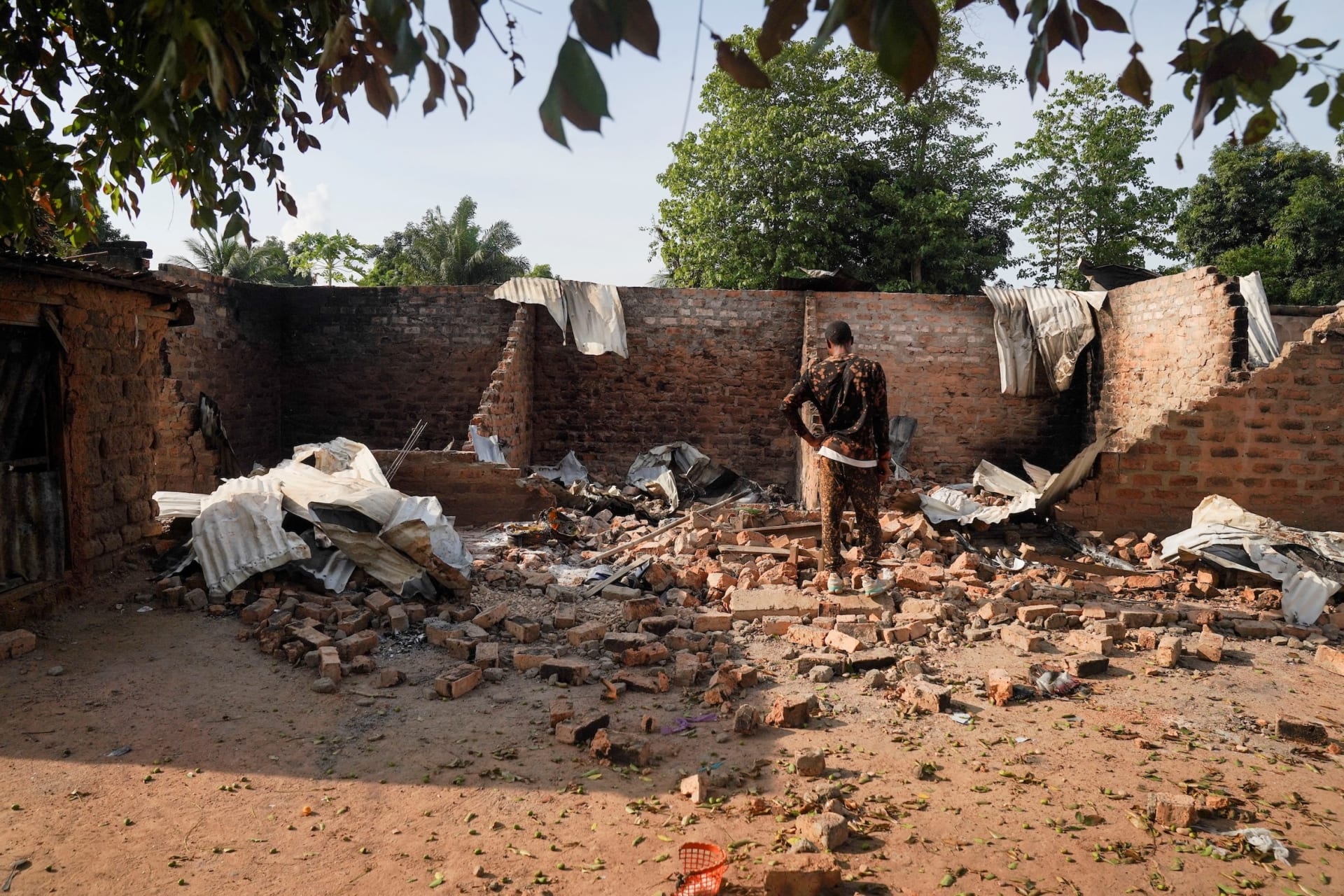 <p>A man stands in front of a damaged and burnt house following a deadly gunmen attack in Yelwata, Benue State, Nigeria on June 16, 2025.</p>

