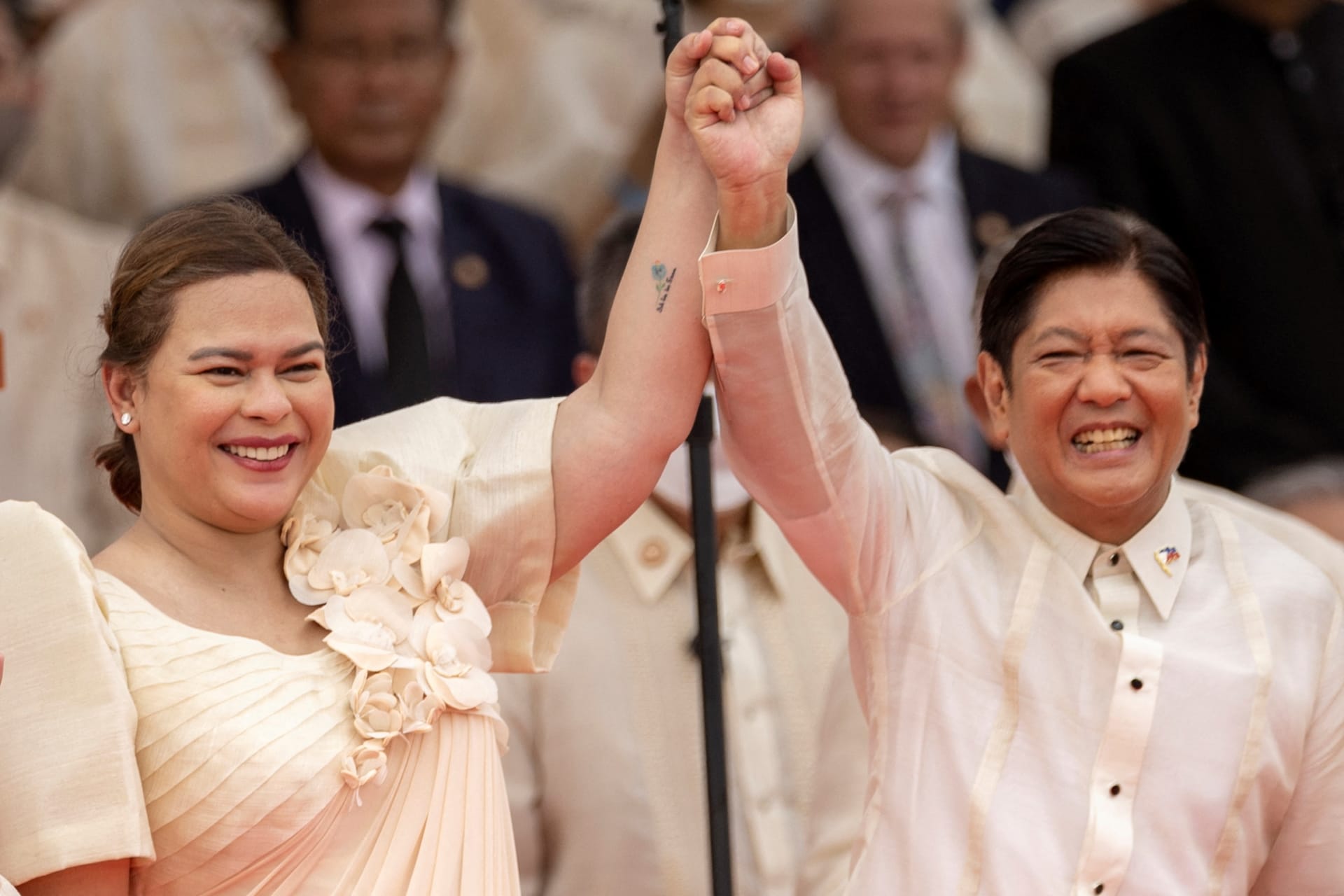 <p>Newly-elected Vice President Sara Duterte raises the arm of newly-elected President Ferdinand “Bongbong” Marcos Jr., during the inauguration ceremony at the National Museum in Manila, Philippines, June 30, 2022.</p>

