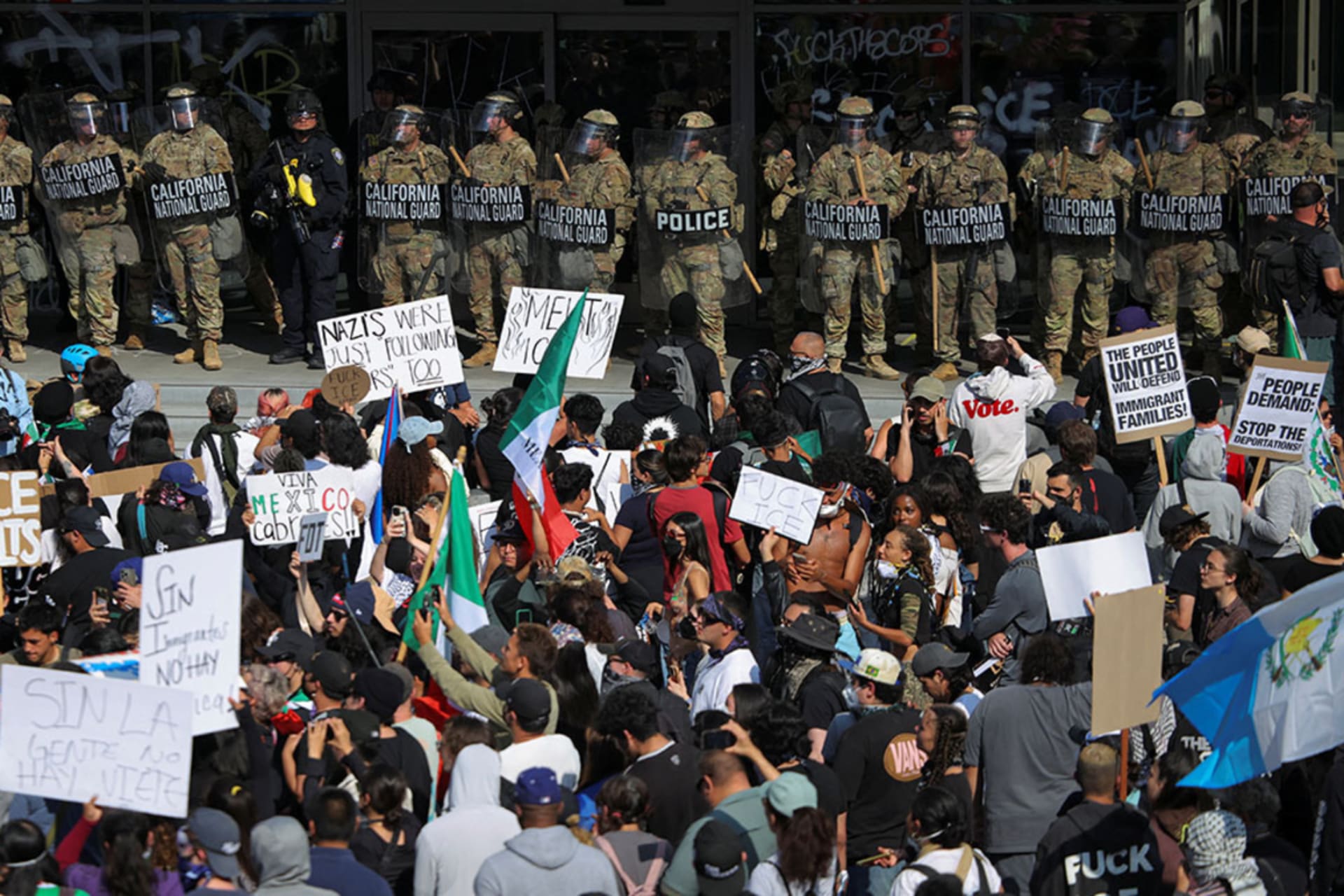<p>Demonstrators gather in front of California National Guard troops, as protests against immigration sweeps continue, in Los Angeles, California, June 9, 2025.</p>
