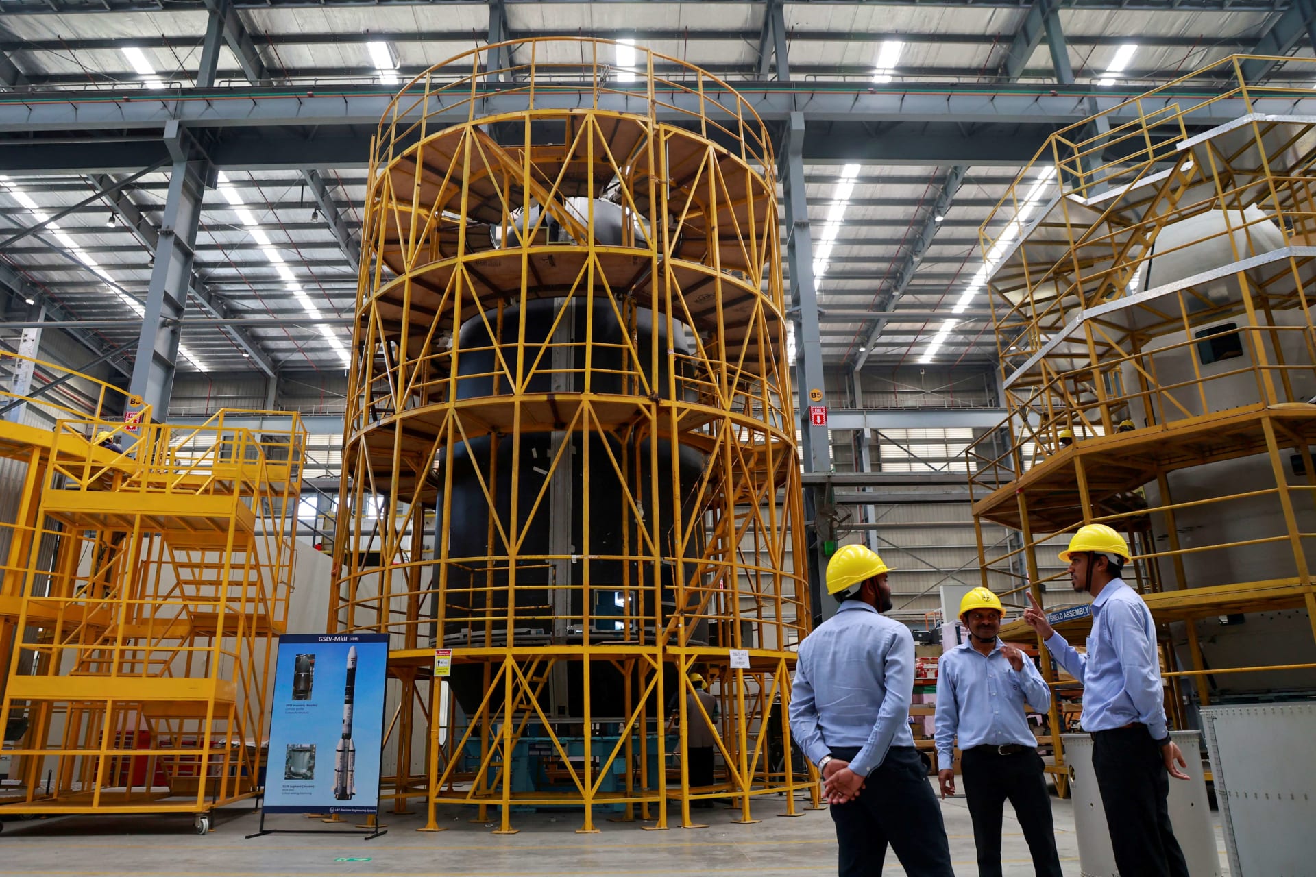 <p>Employees stand next to Heat Shield of Geosynchronous Satellite Launch Vehicle (GSLV) Mark II inside a manufacturing facility of the Larsen & Toubro Precision Manufacturing and Systems Complex on the outskirts of Coimbatore, India, February 26, 2025.</p>
