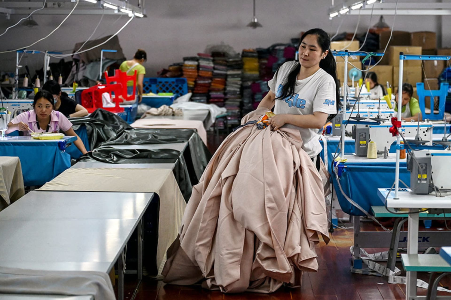 <p>A worker carries curtains at a textile company in Shaoxing, China, May 9, 2025.</p>
