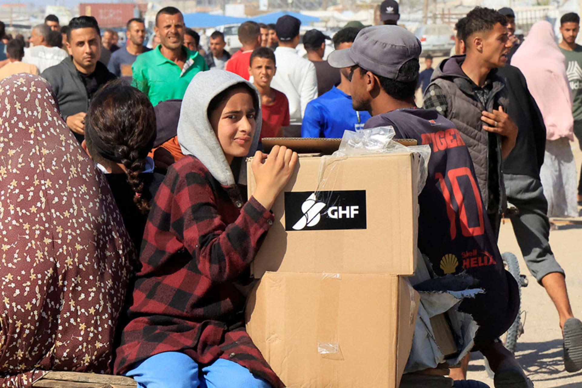 <p>Palestinians seek aid near an aid distribution site run by the Gaza Humanitarian Foundation, in Rafah, in the southern Gaza Strip.</p>
