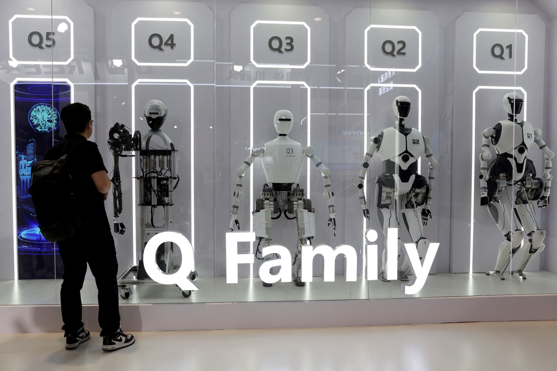 <p>A visitor looks at humanoid robots displayed at the Institute of Automation, Chinese Academy of Sciences booth during the World Robot Conference in Beijing, China August 21, 2024.</p>
