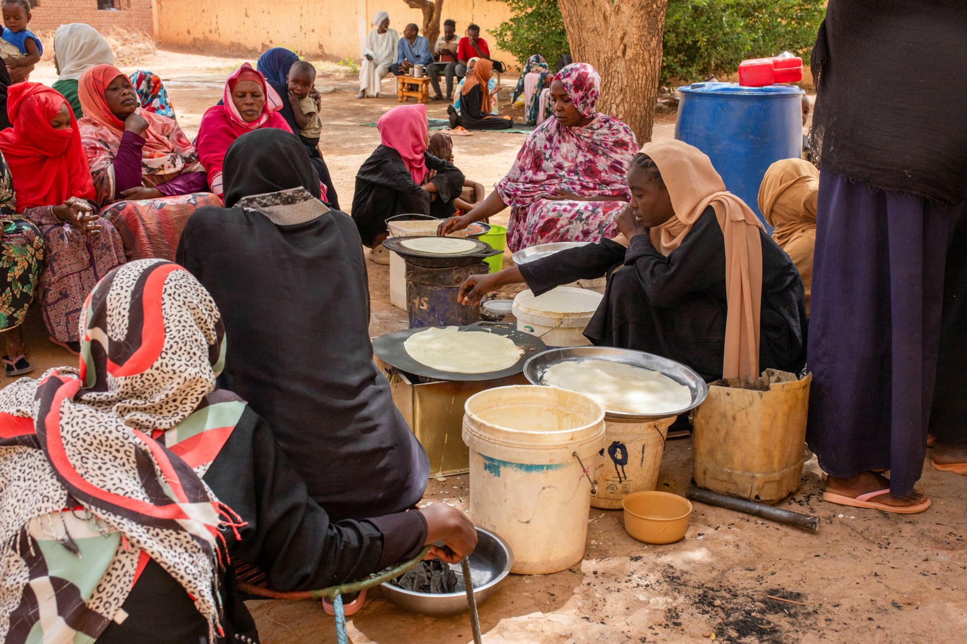 <p>Sudanese women from community kitchens, run by local volunteers, prepare meals for people who are affected by conflict and extreme hunger and are out of reach of international aid efforts, in Omdurman, Sudan, May 13, 2024.</p>
