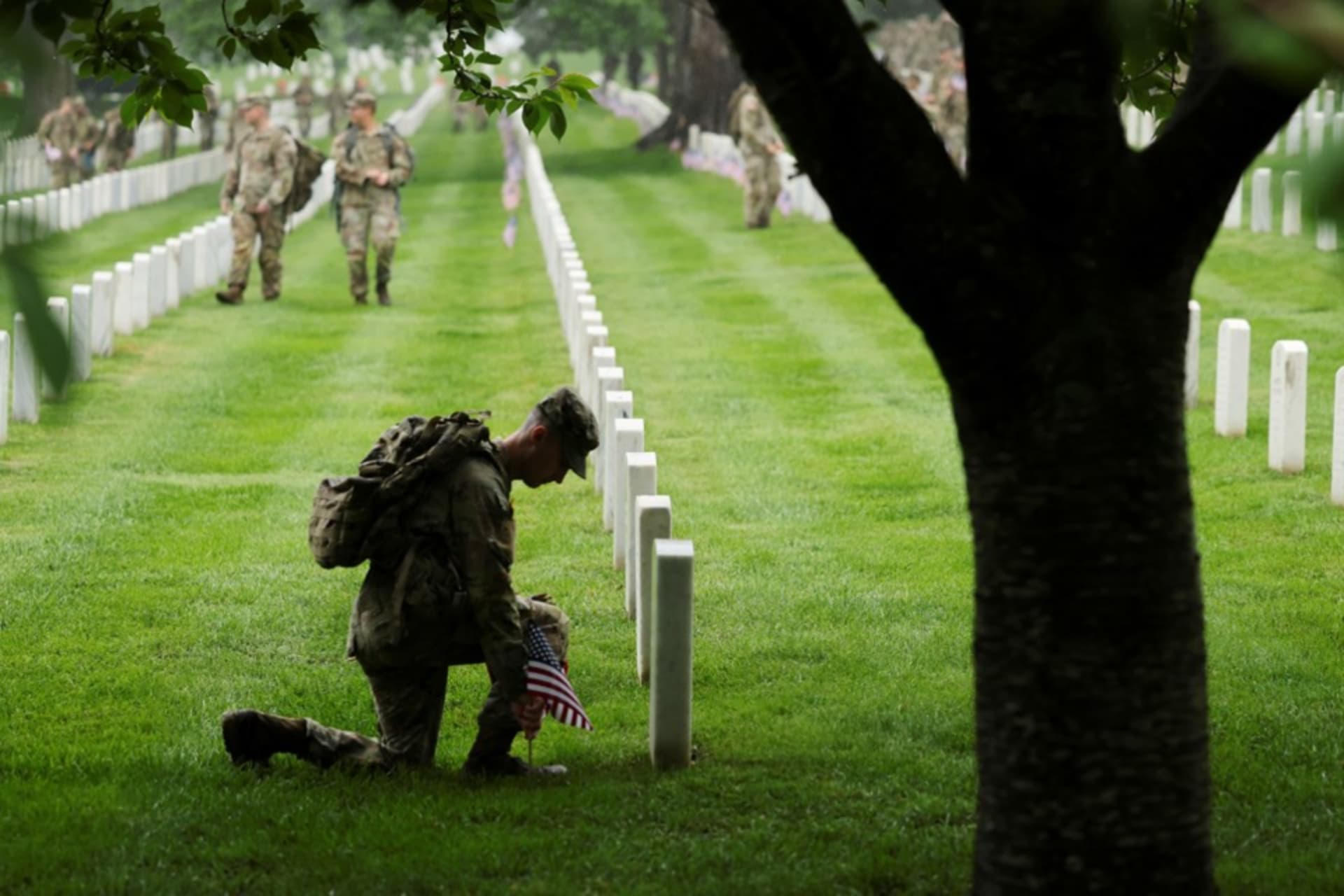<p>A soldier from the U.S. Army 3d Infantry Regiment plants a flag in front of a headstone in advance of Memorial Day at Arlington National Cemetery on May 22, 2025. </p>
