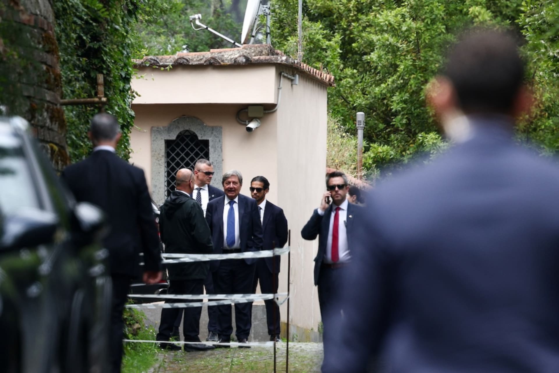 <p>Delegation members stand with security as they arrive at the Omani embassy, where the fifth round of U.S.-Iran talks takes place, in Rome, Italy, May 23, 2025. </p>
