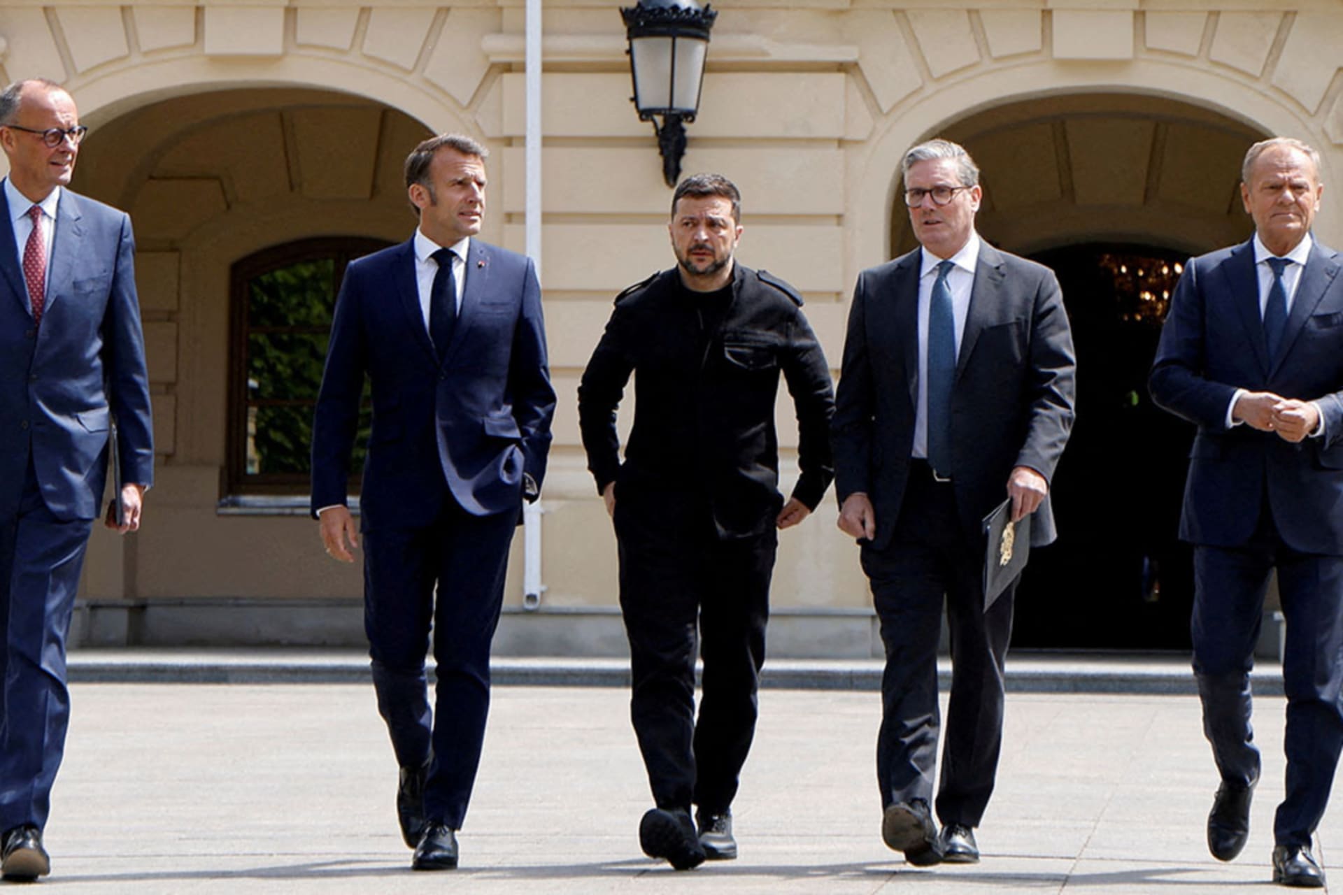 <p>German Chancellor Friedrich Merz, French President Emmanuel Macron, Ukranian President Voloydmyr Zelenskyy, British Prime Minister Keir Starmer and Polish Prime Minister Donald Tusk walk in the grounds of Mariynsky Palace, in Kyiv, Ukraine, on May 10.</p>

