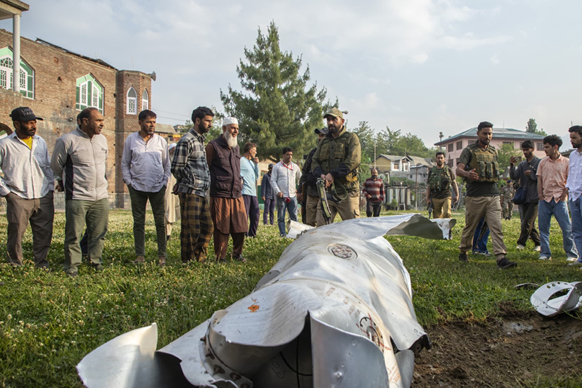 <p>People look at a part of a downed aircraft near India-administered Kashmir’s city Srinagar.</p>
