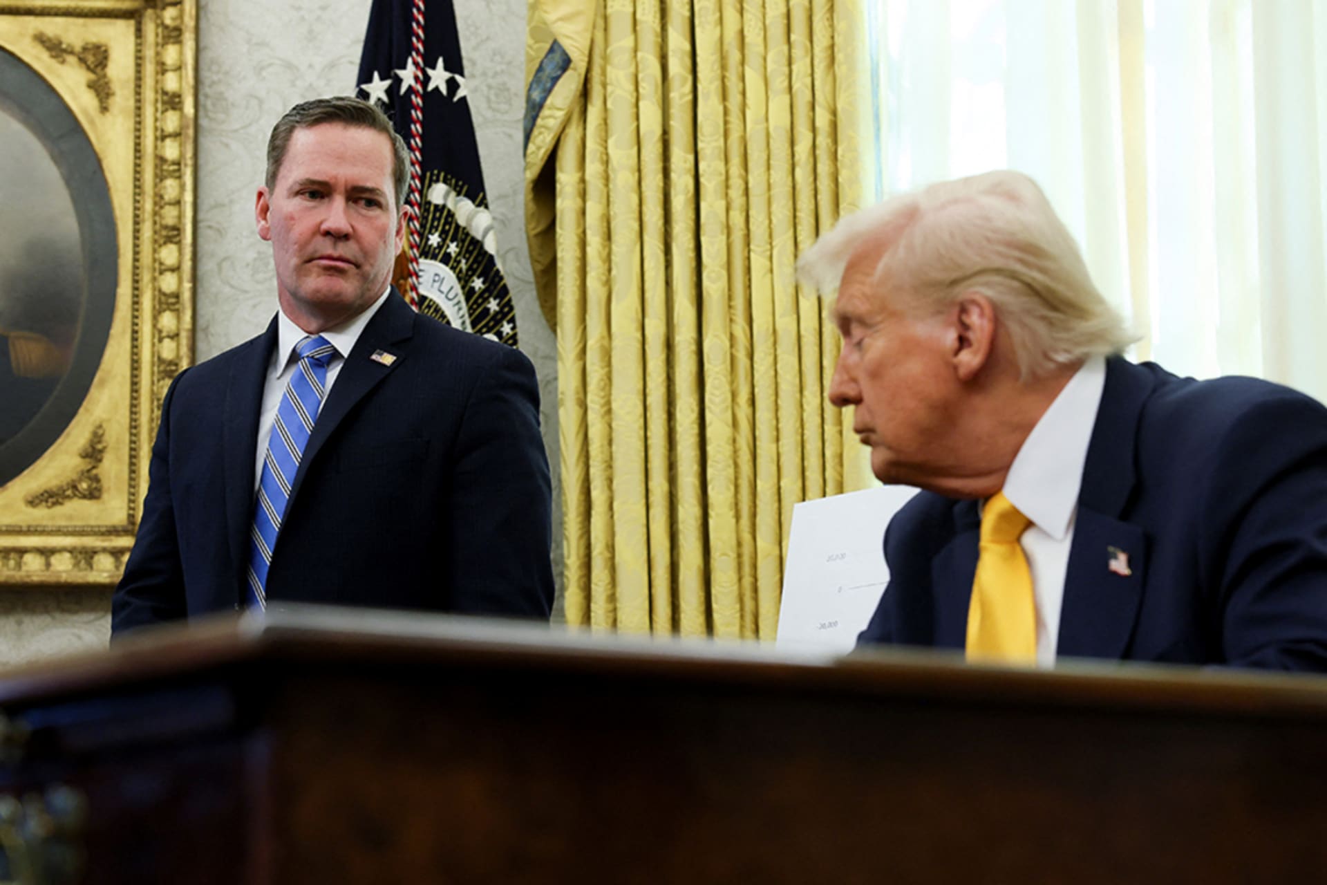 <p>U.S. National Security Advisor Michael Waltz stands next to President Donald Trump in the Oval Office, March 7, 2025.</p>
