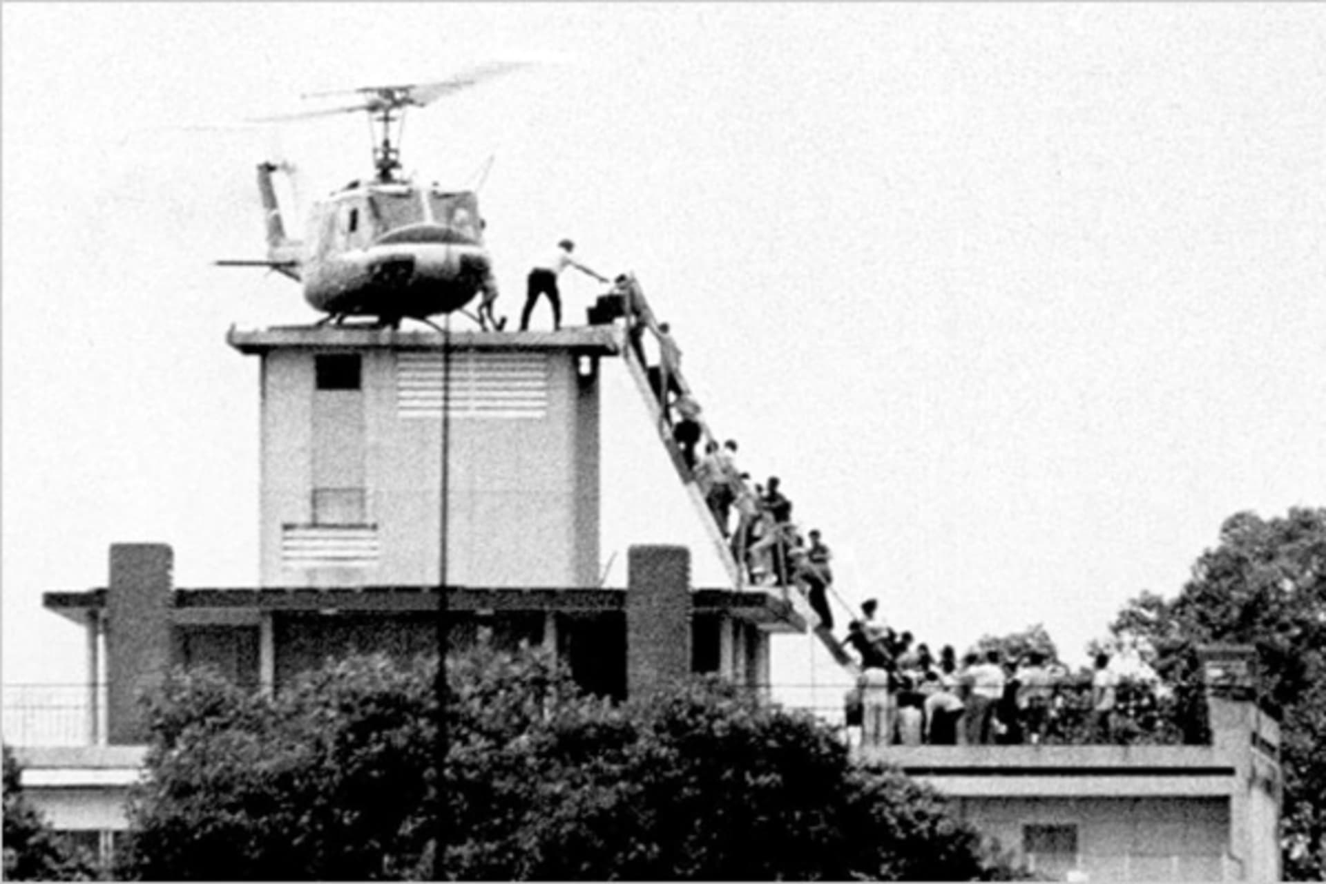<p>Evacuees are helped aboard an Air America helicopter perched on top of a building in Saigon on April 30, 1975.</p>
