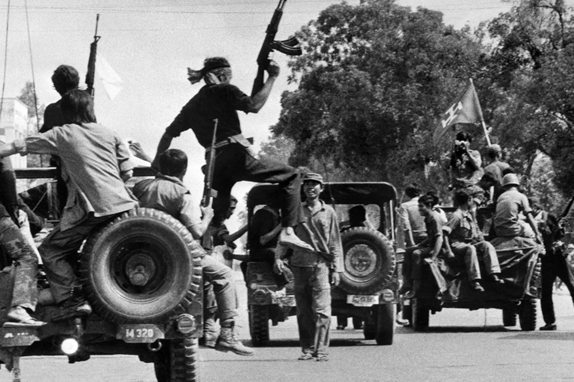 <p>Members of the MONATIO (Mouvement National) group drive atop jeeps through a street of Phnom Penh on April 17, 1975, the day Cambodia fell under control of Khmer Rouge forces.</p>
