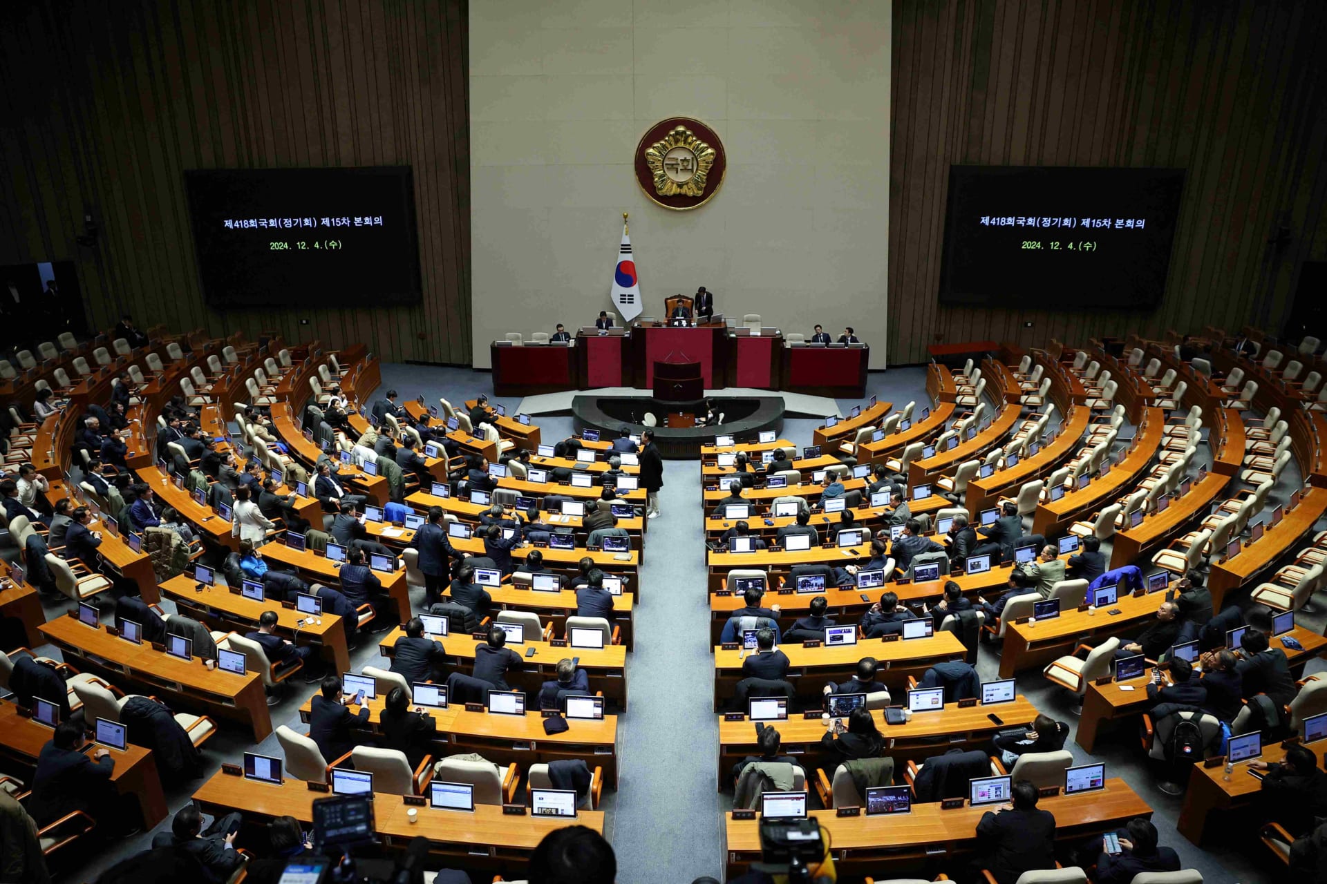 <p>Lawmakers sit inside the hall at the National Assembly, after South Korean President Yoon Suk Yeol declared martial law</p>
