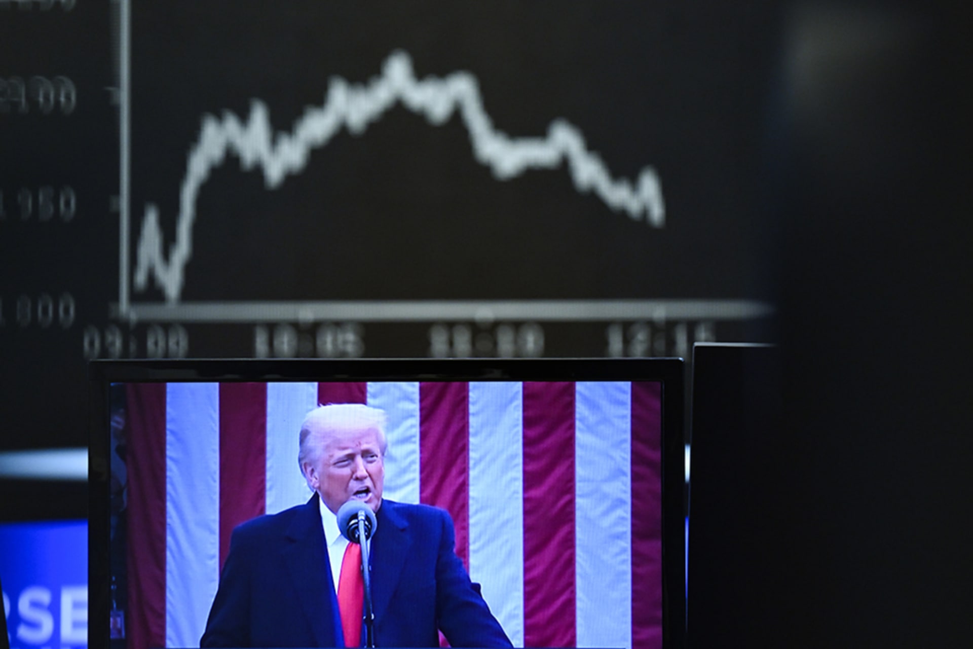 <p>Behind a television monitor showing U.S. President Donald Trump, the display board with the Dax curve shows falling share prices on April 3, 2025 in Frankfurt, Germany. </p>
