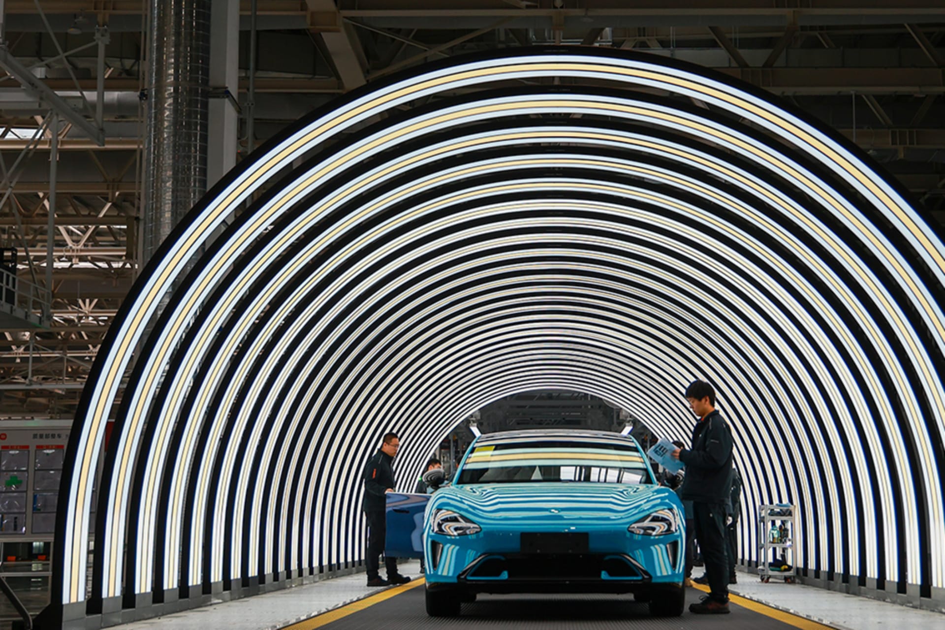 <p>Employees work on the production line of electric vehicles at Xiaomi’s Electric Vehicle Factory in Beijing, China.</p>
