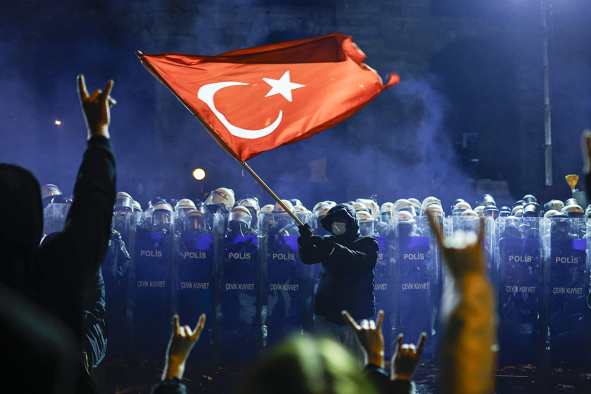 <p>A protester waves Turkey’s flag before riot police as protesters flash the grey-wolf salute during a demonstration outside the city hall to support mayor Ekrem İmamoğlu following his arrest in Istanbul, Turkey, March 22, 2025.</p>
