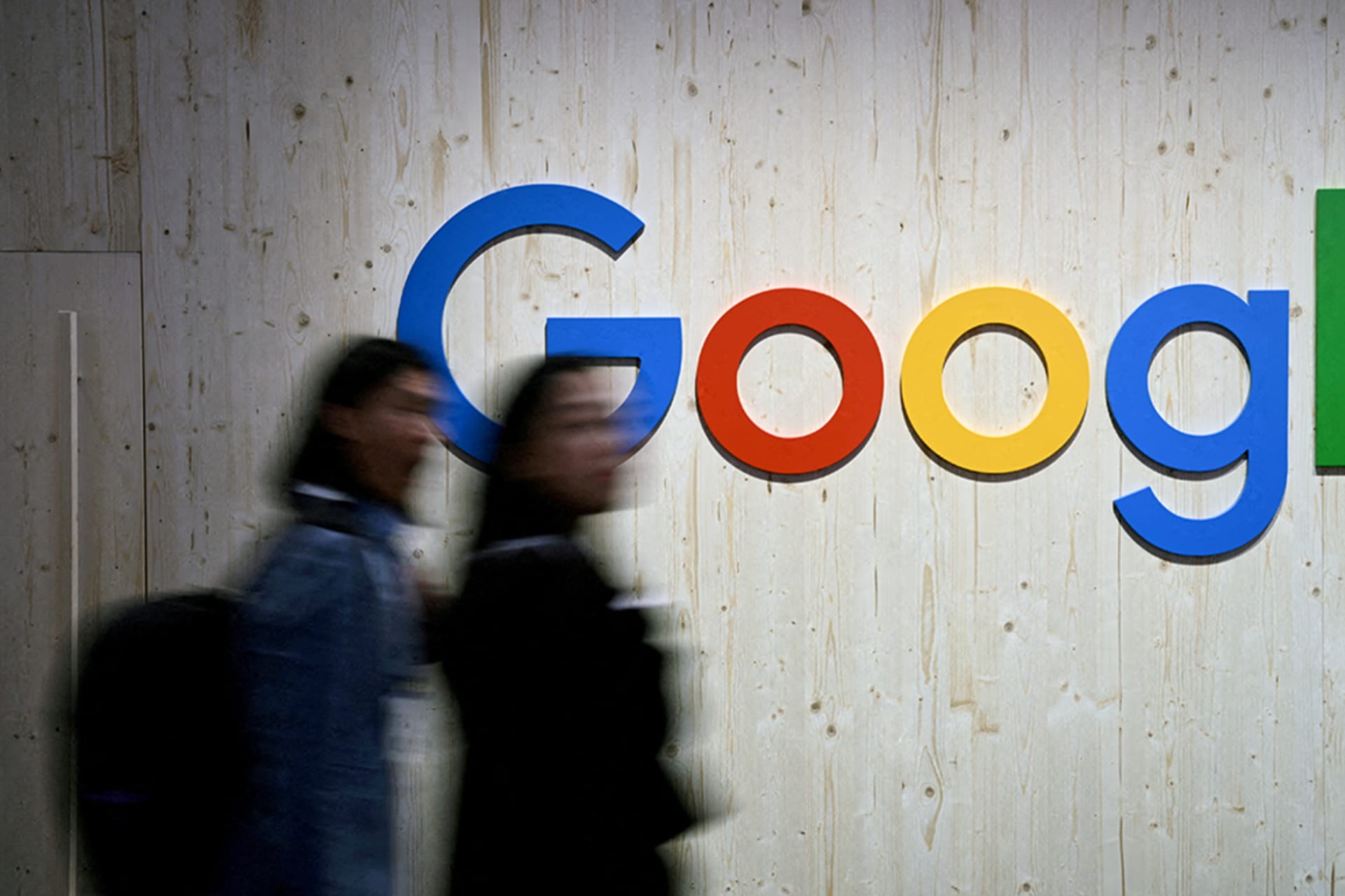 <p>People walk next to a Google logo during a trade fair in Hannover Messe, in Hanover, Germany, April 22, 2024.</p>
