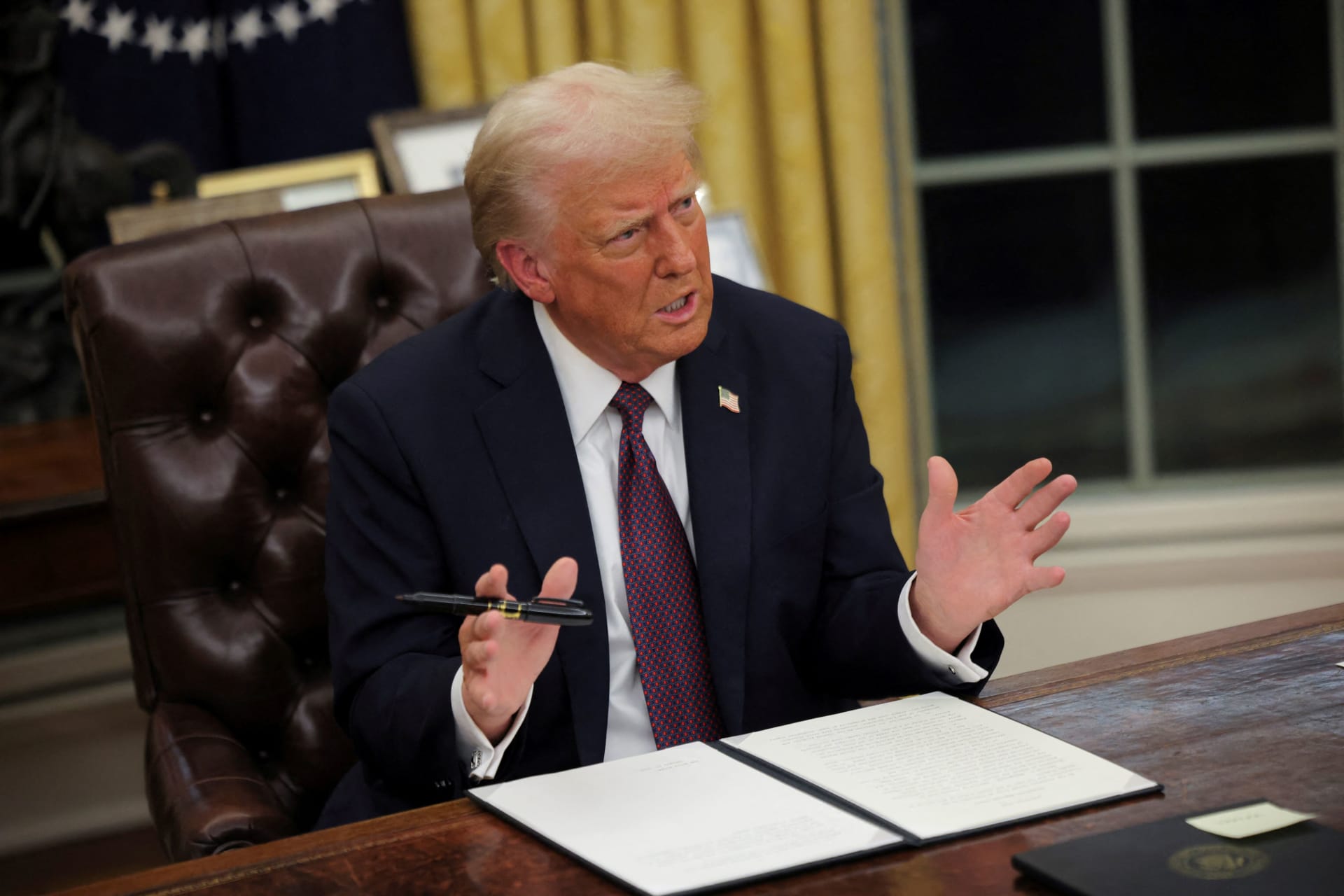 <p>U.S. President Donald Trump signs documents as he issues executive orders, including one freezing foreign aid to institutions like the National Endowment for Democracy, at the White House on January 20, 2025. </p>
