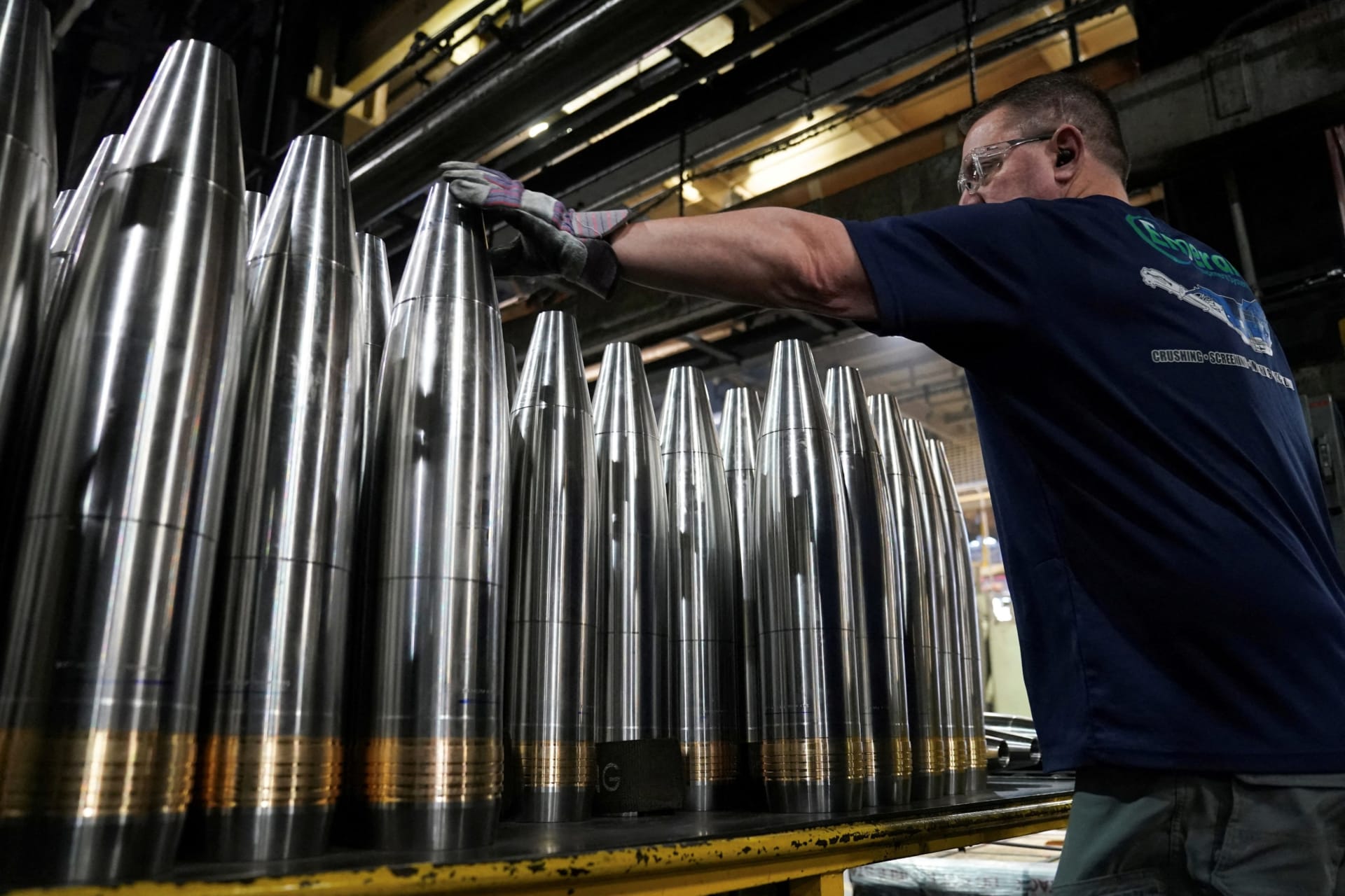 <p>A worker along the assembly line handles large caliber 155mm metal projectiles at the Scranton Army Ammunition Plant in Scranton, Pennsylvania, U.S., April 16, 2024.</p>

