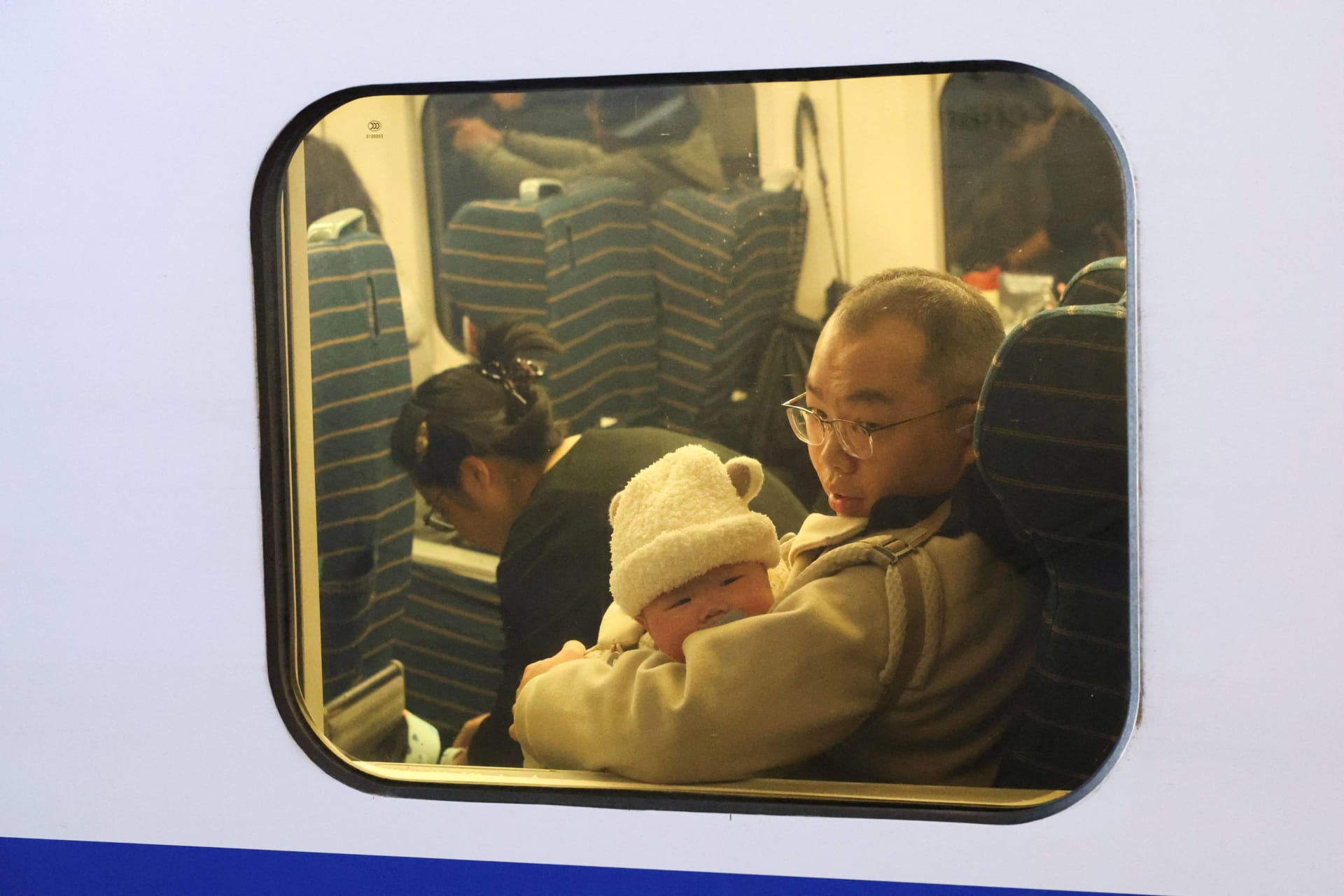 <p>A baby looks out a window of the train during the Spring festival travel rush ahead of the Lunar New Year, at Shanghai Hongqiao railway station in Shanghai, China, January 24, 2025. </p>
