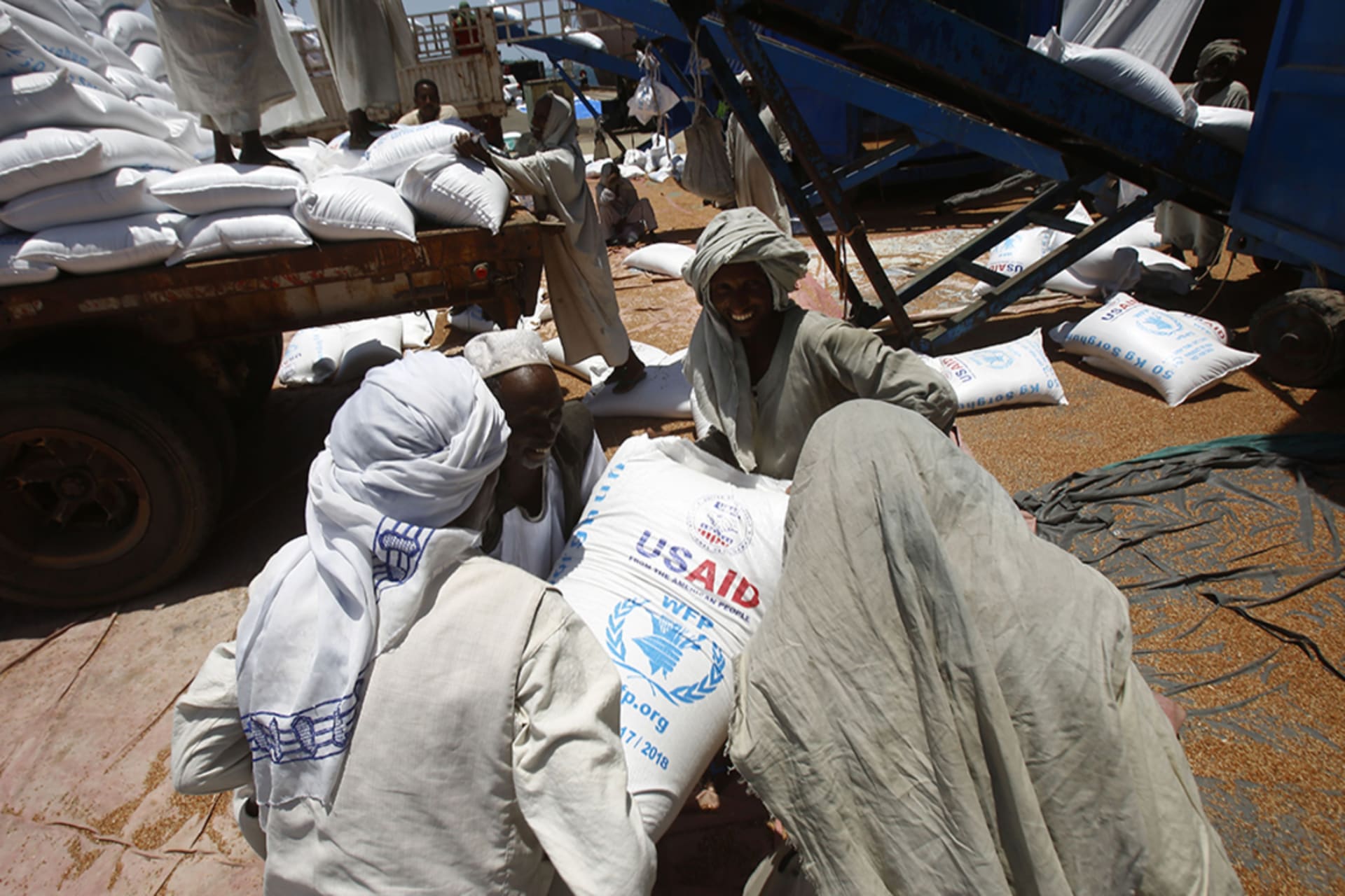 <p>Sudanese dockers unload bags of cereal from U.S. ships carrying humanitarian aid supplies provided by USAID, at Port Sudan on the Red Sea.</p>
