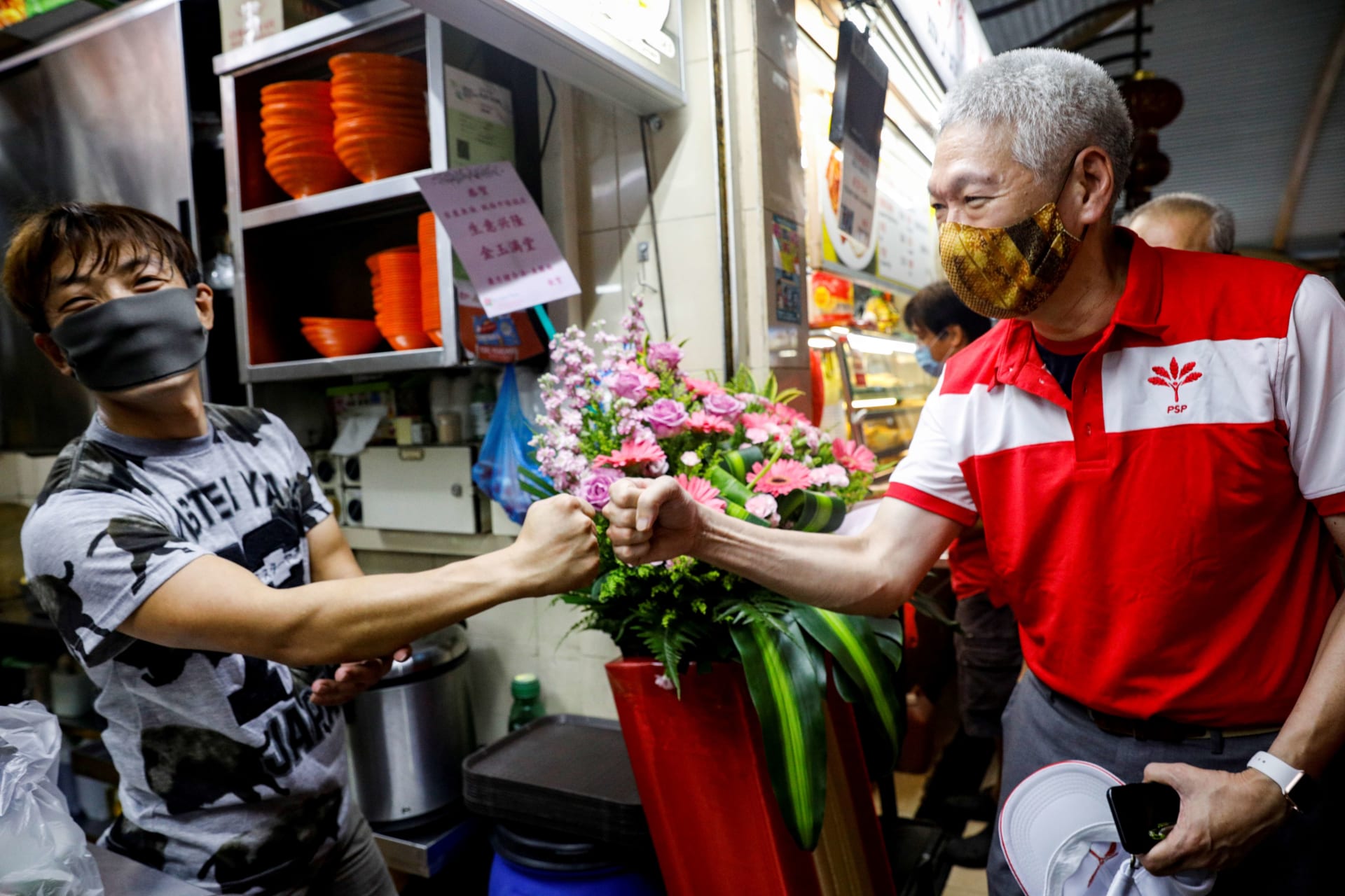 <p>Lee Hsien Yang of the Progress Singapore Party (PSP) greets a hawker during a walkabout ahead of the last general election in Singapore on June 28, 2020. </p>
