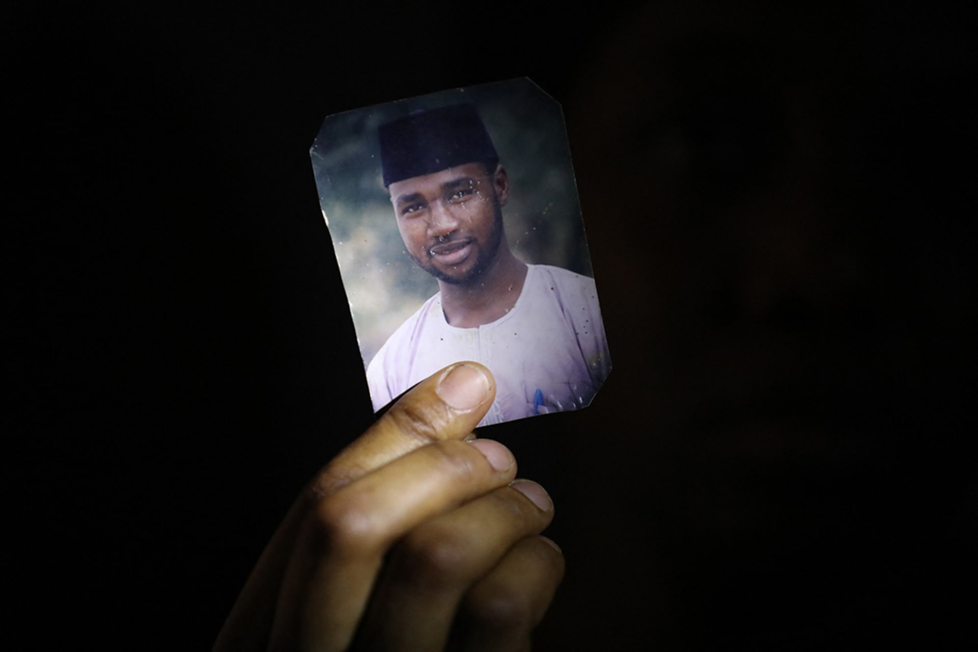 <p>Amina Ahmed, wife of Mubarak Bala, an outspoken atheist who was charged with blasphemy, displays her husband’s photo at their home in Abuja, Nigeria on March 11, 2021.</p>

