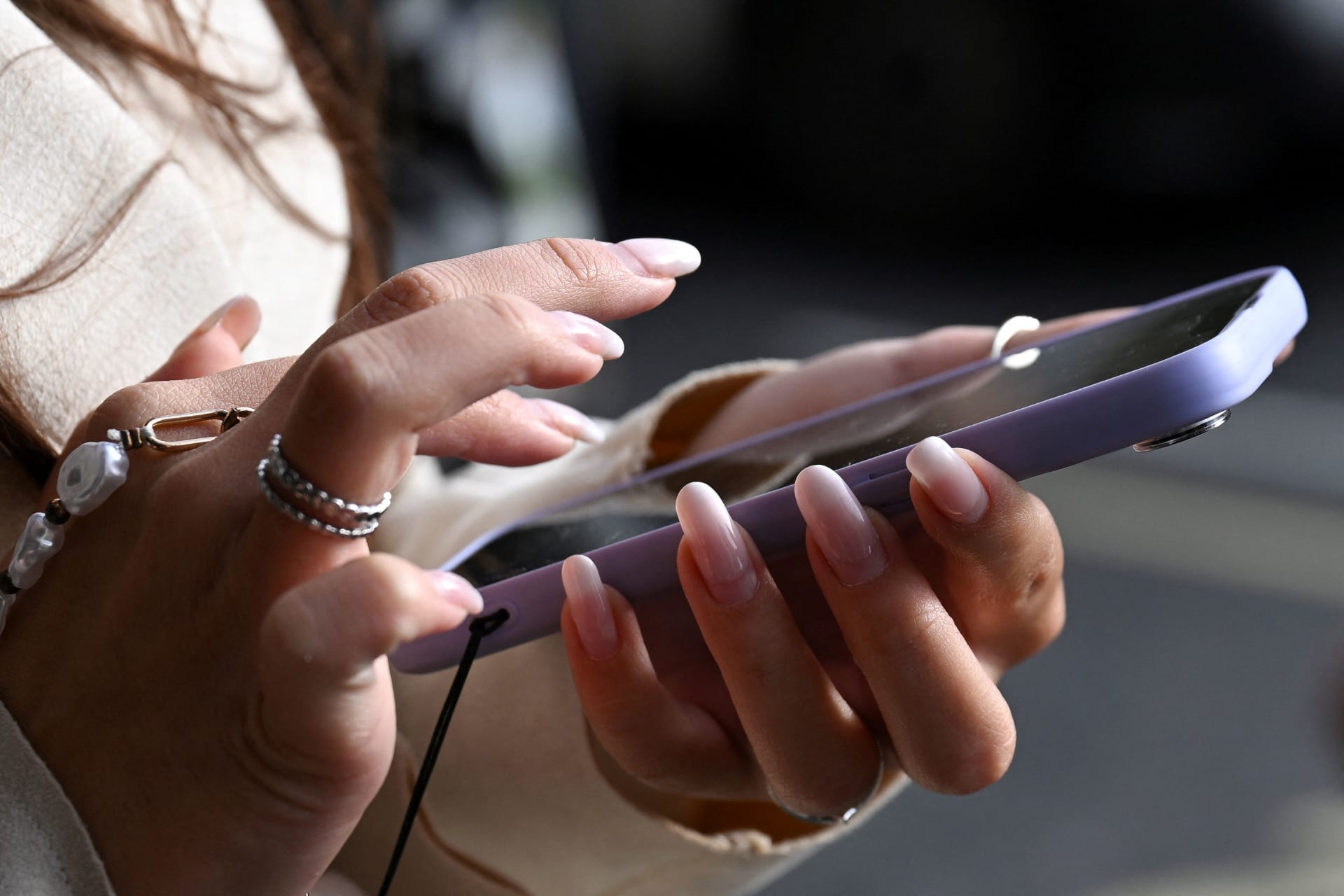 <p>A woman holds her phone on the street in Westminster, in London, Britain, October 11, 2024.</p>
