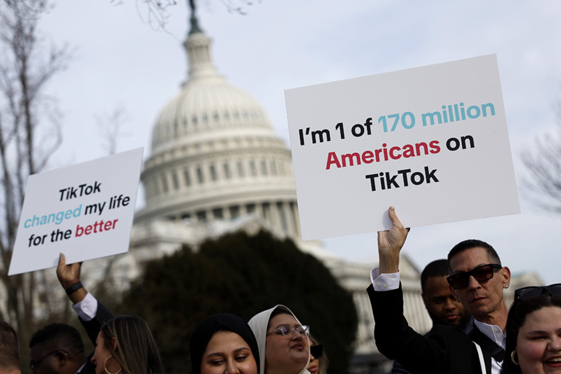 <p>Participants hold signs in support of TikTok outside the U.S. Capitol Building.</p>
