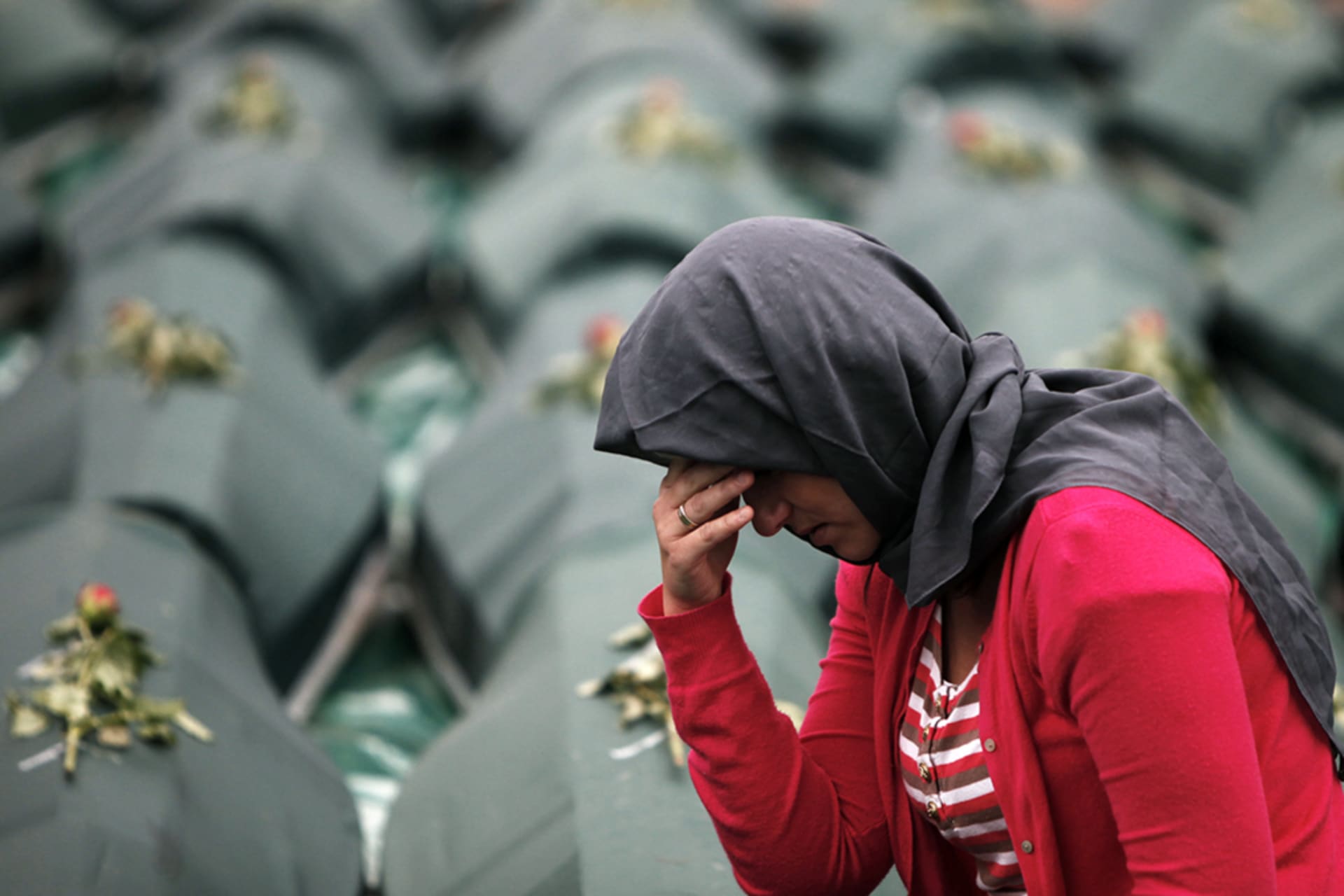 <p>A Bosnian Muslim woman cries next to coffins during a mass funeral in Visegrad, Bosnia and Herzegovina, May 26, 2012. </p>
