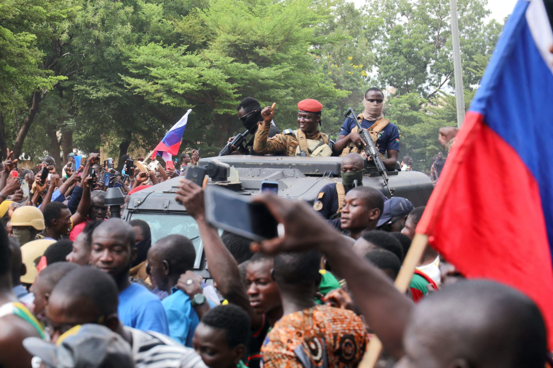 <p>Burkina Faso’s self-declared leader Ibrahim Traoré is welcomed by supporters holding Russian flags as he arrives at the national television station in Ouagadougou, Burkina Faso on October 2, 2022.</p>
