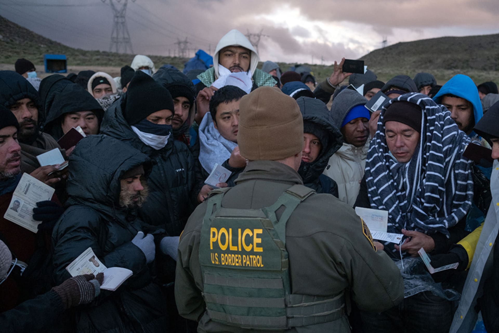 <p>A Border Patrol agent processes asylum seekers at an improvised camp in California near the U.S.-Mexico border.</p>
