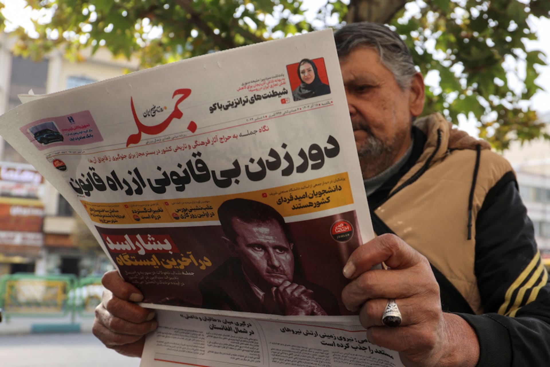 <p>An Iranian man reads a newspaper with a picture of Syrian President Bashar al-Assad in Tehran, Iran, December 8, 2024.</p>
