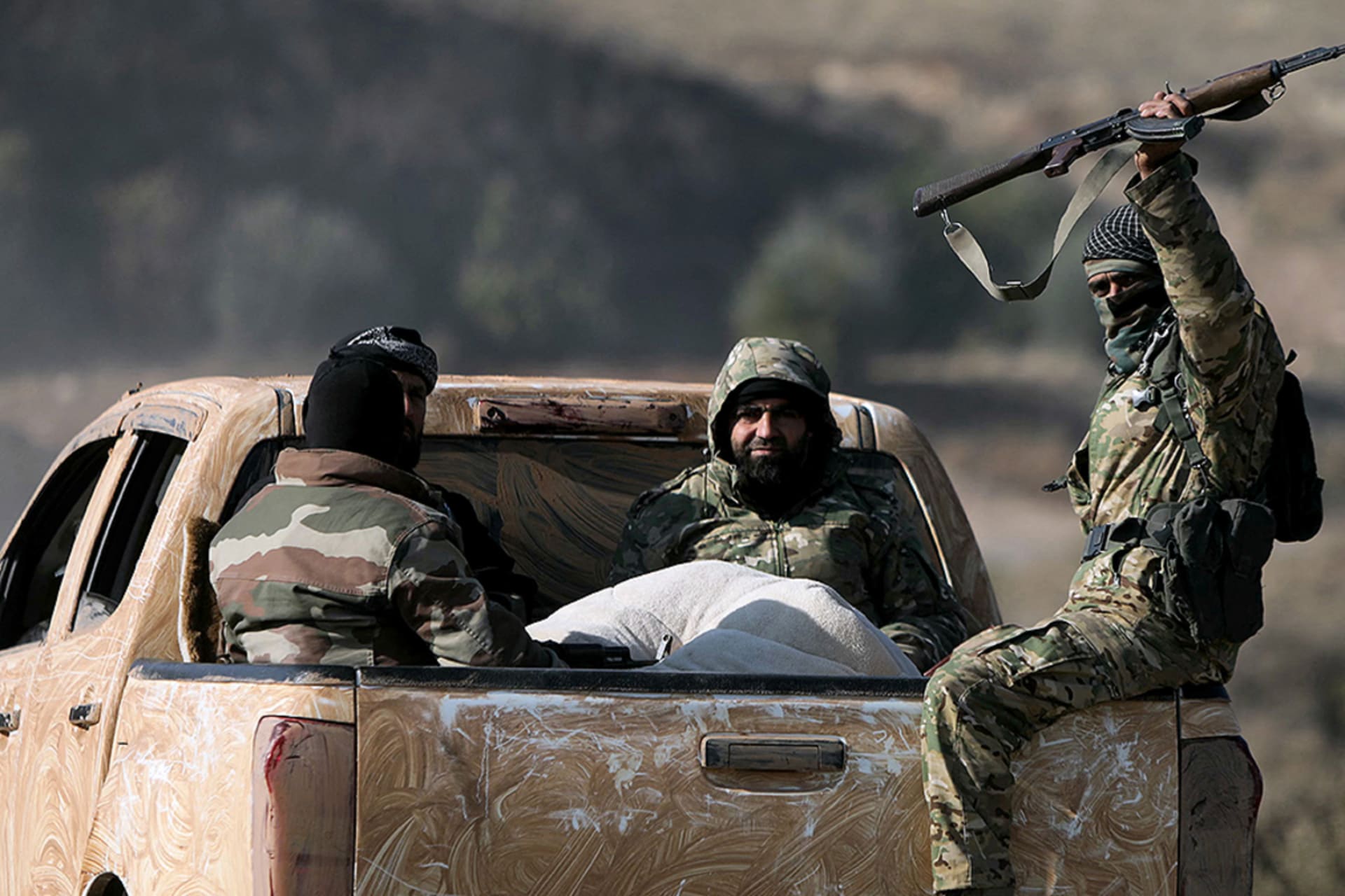 <p>Anti-government fighters ride in the back of a truck in Suran, between Aleppo and Hama, Syria, on December 3, 2024.</p>
