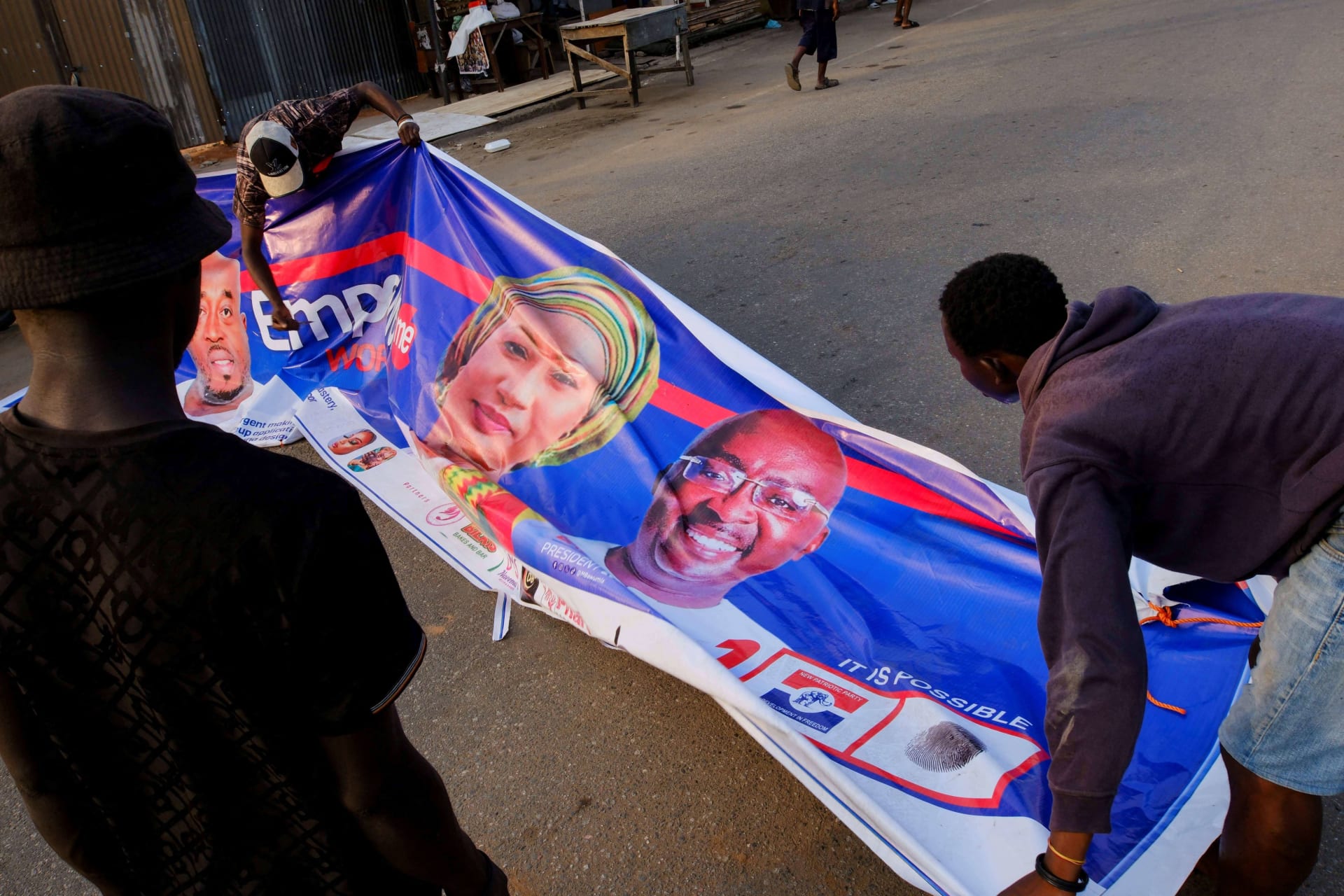 <p>Young men prepare a banner of the presidential candidate of Ghana’s ruling New Patriotic Party, Mahamudu Bawumia, ahead of the elections on December 7, in Accra, Ghana on December 2, 2024.</p>
