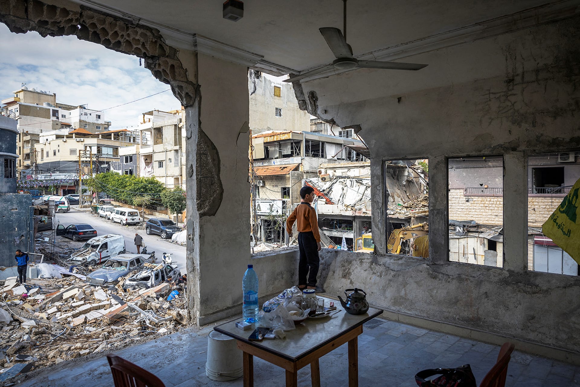 <p>A boy stands inside his damaged house in Tyre, Lebanon, in November 2024.</p>
