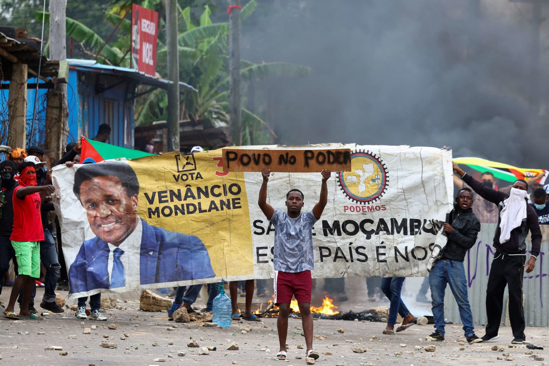 <p>Protesters hold a banner with the face of Venancio Mondlane, independent candidate for the presidency of Mozambique during a “national shutdown” against the election outcome, in Maputo, Mozambique, on November 7, 2024.</p>
