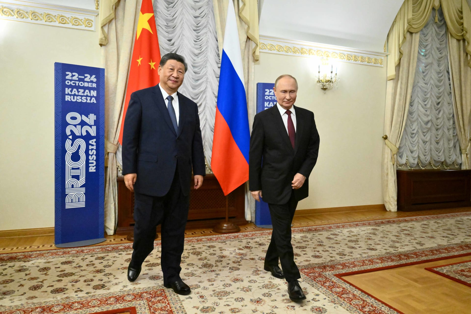 <p>Russian President Vladimir Putin and Chinese President Xi Jinping walk during a meeting on the sidelines of the BRICS Summit in Kazan, Russia October 22, 2024.</p>

