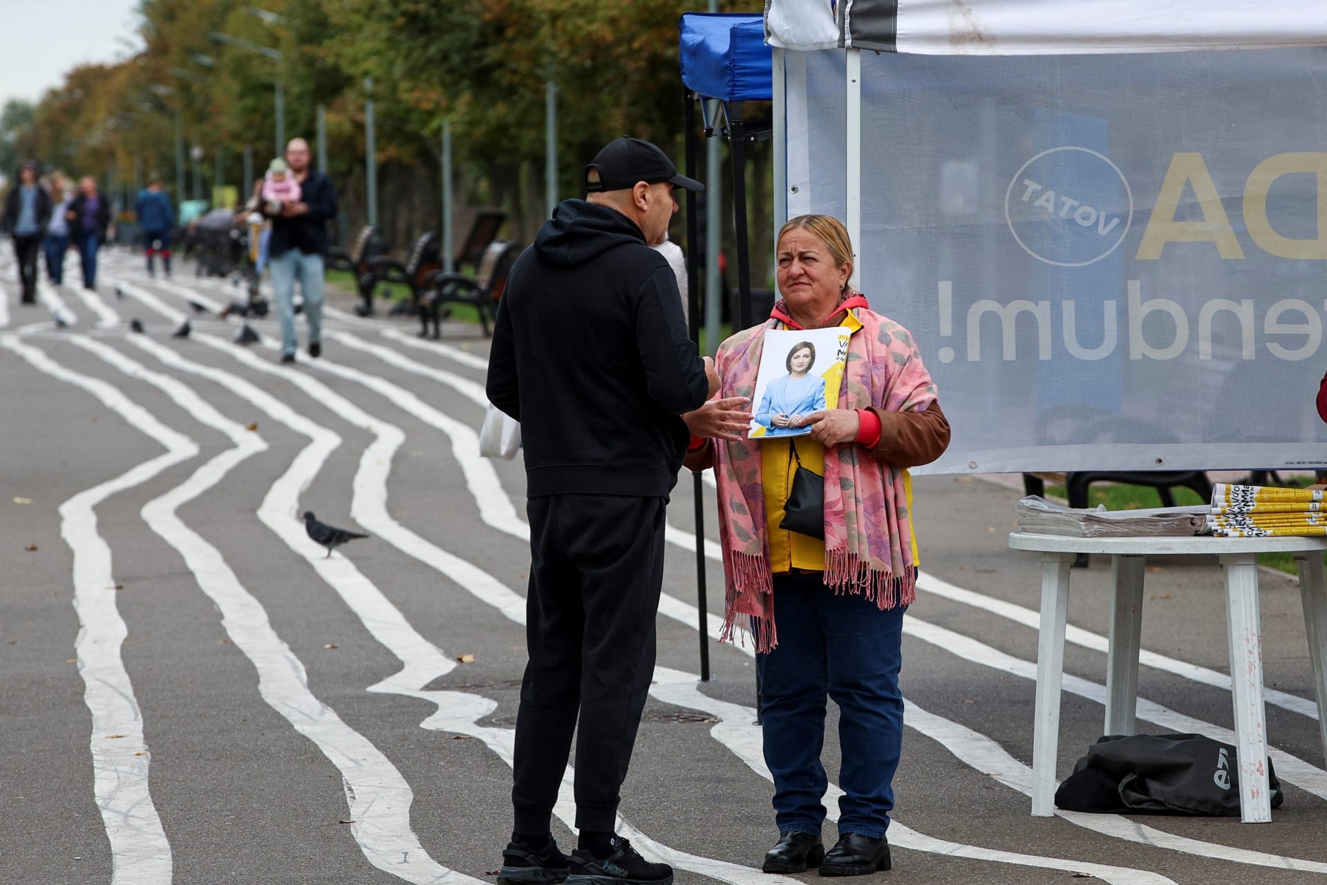 <p>A participant of Moldovan incumbent President and presidential candidate Maia Sandu’s campaign agitates voters in a street ahead of the country’s upcoming presidential election and a referendum on future European Union membership, in Chisinau, Moldova.</p>
