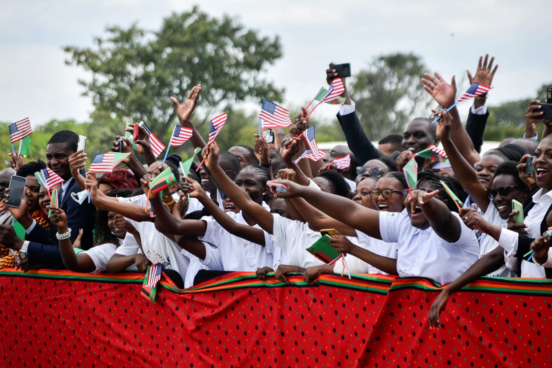 <p>People cheer and wave American and Zambian flags during the visit of Vice President Kamala Harris in Lusaka, Zambia, on March 31, 2023. </p>
