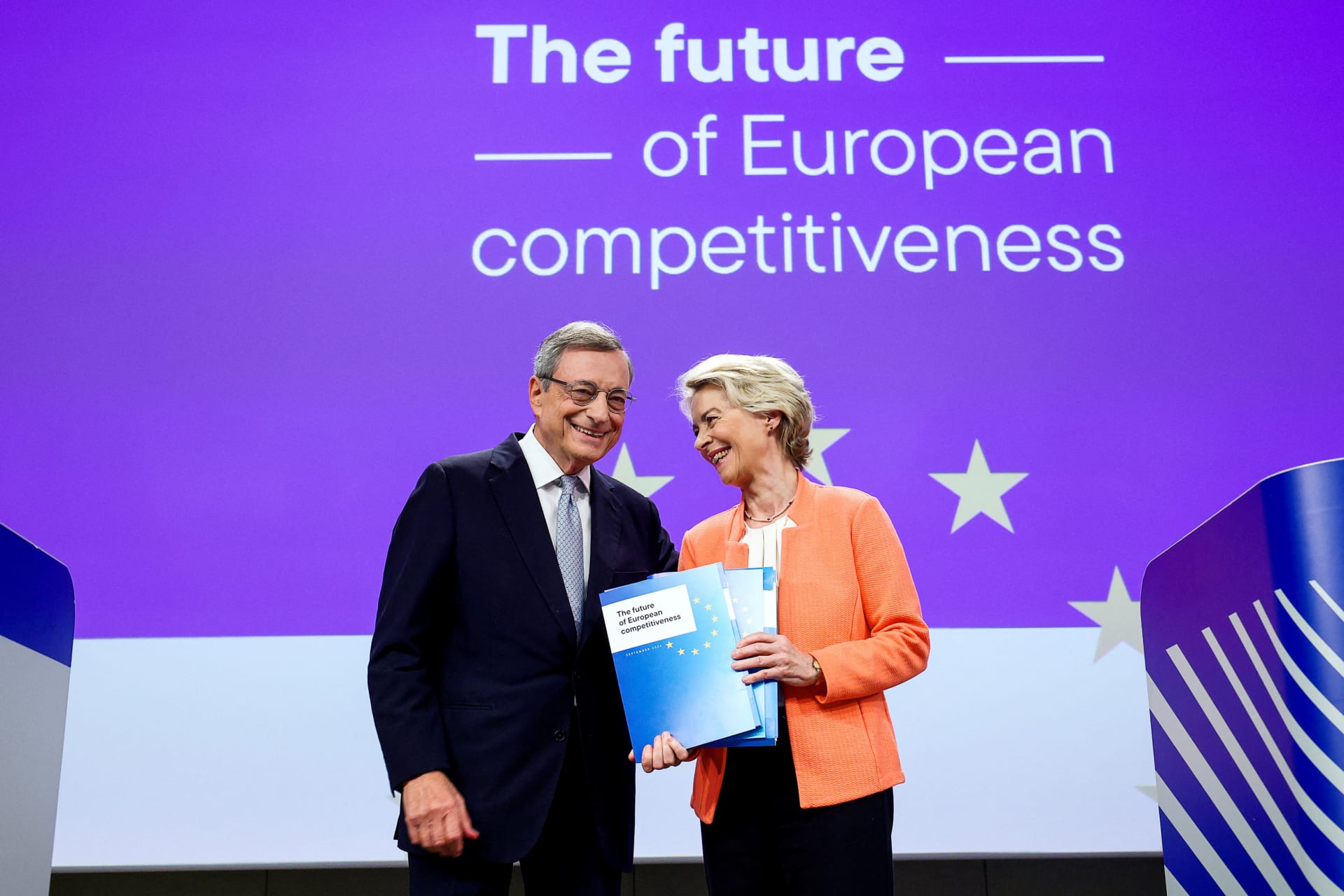 <p>European Commission President Ursula von der Leyen holds Former European Central Bank (ECB) chief Mario Draghi’s report on EU competitiveness and recommendations, as they attend a press conference, in Brussels, Belgium on September 9, 2024</p>
