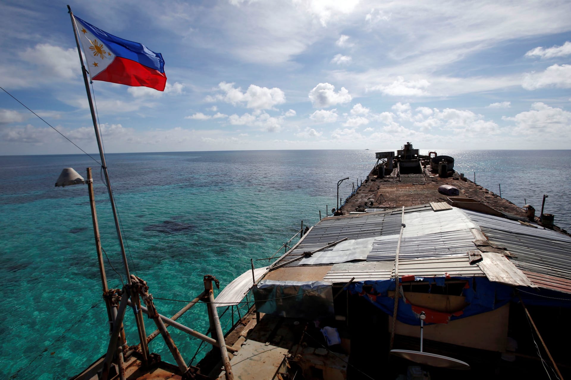 <p>A Philippine national flag flutters in the wind aboard the BRP Sierra Madre, run aground on the disputed Second Thomas Shoal of the Spratly Islands in the South China Sea on March 29, 2014.</p>
