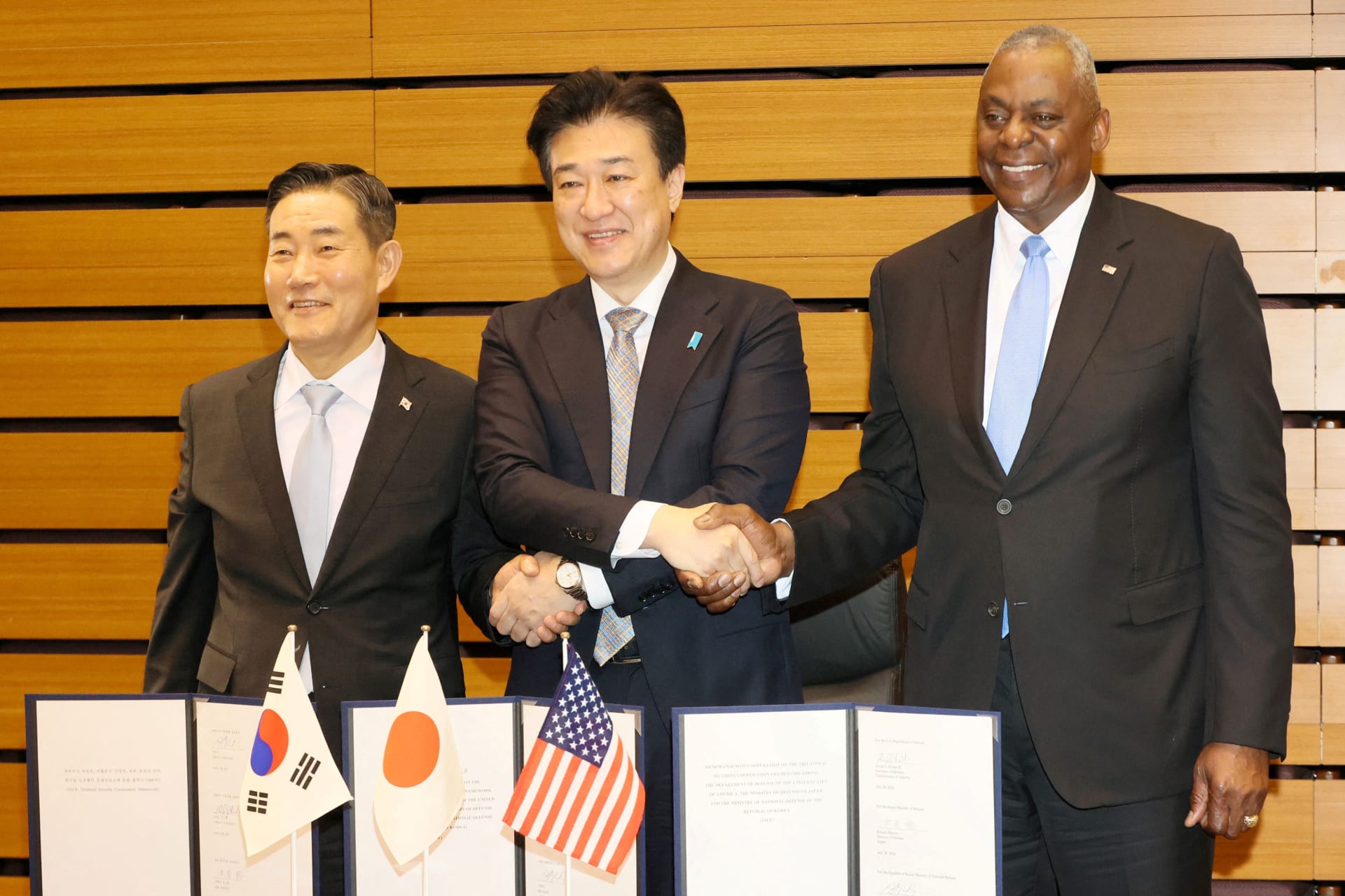 <p>U.S. Secretary of Defense Lloyd Austin, Japanese Defense Minister Minoru Kihara and South Korean Defense Minister Shin Won-sik shake hands after a Japan-US-South Korea trilateral defense ministers meeting in Tokyo on July 28, 2024.</p>
