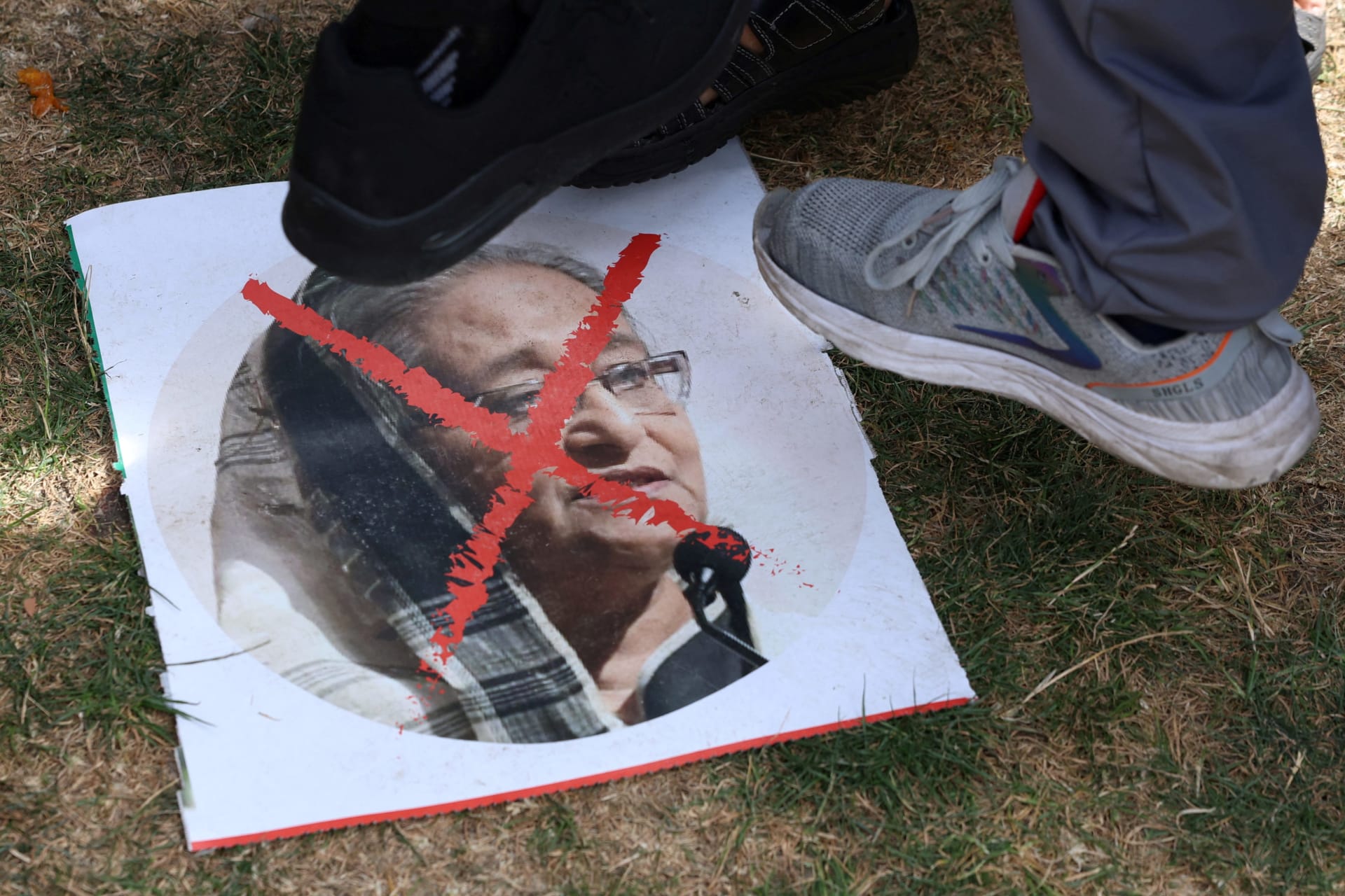 <p>People step on an image as they react to the resignation of Bangladeshi Prime Minister Sheikh Hasina, in East London, Britain, August 5, 2024.</p>
