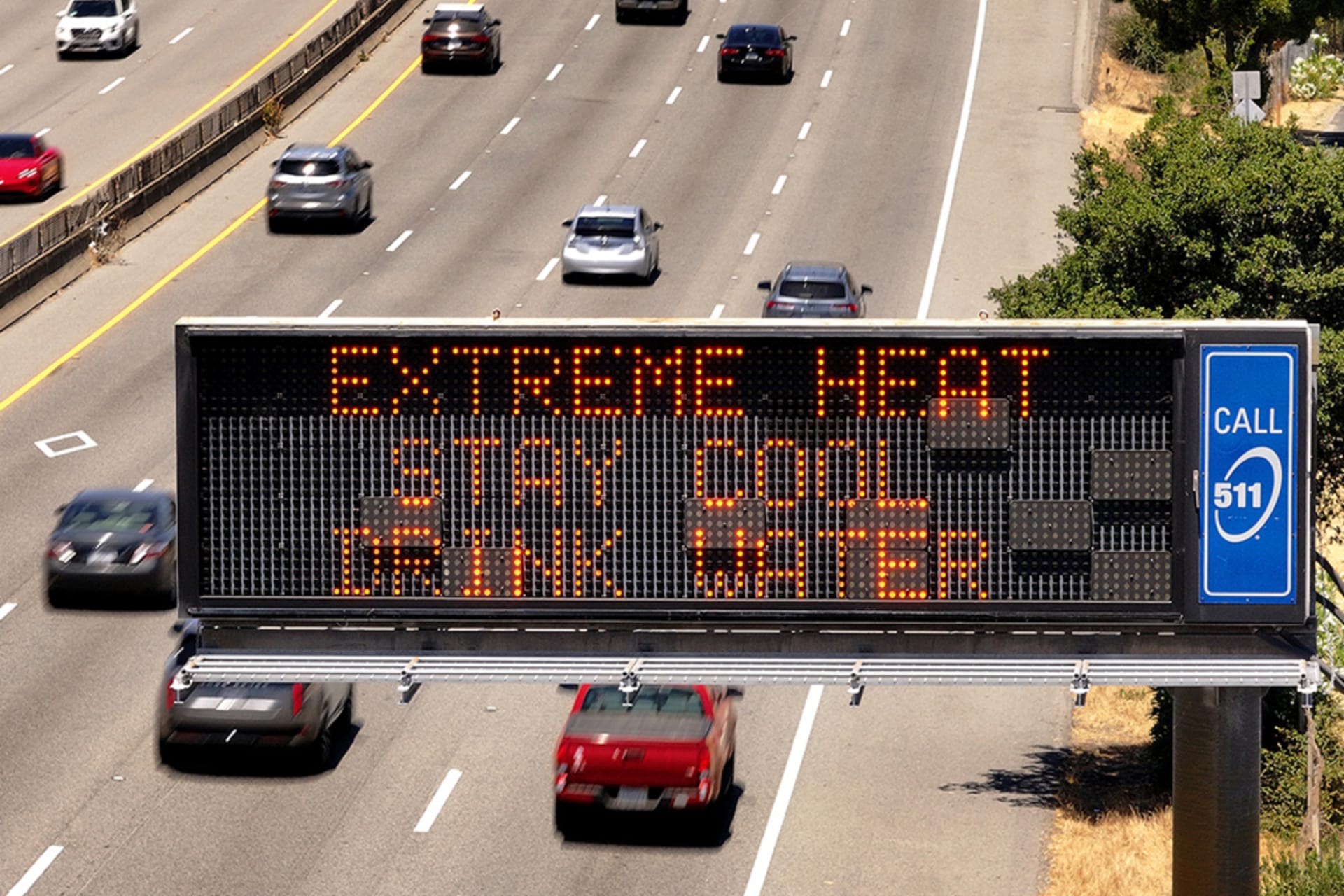 <p>A highway sign displays a heat warning in the desert north of San Francisco, California.</p>

