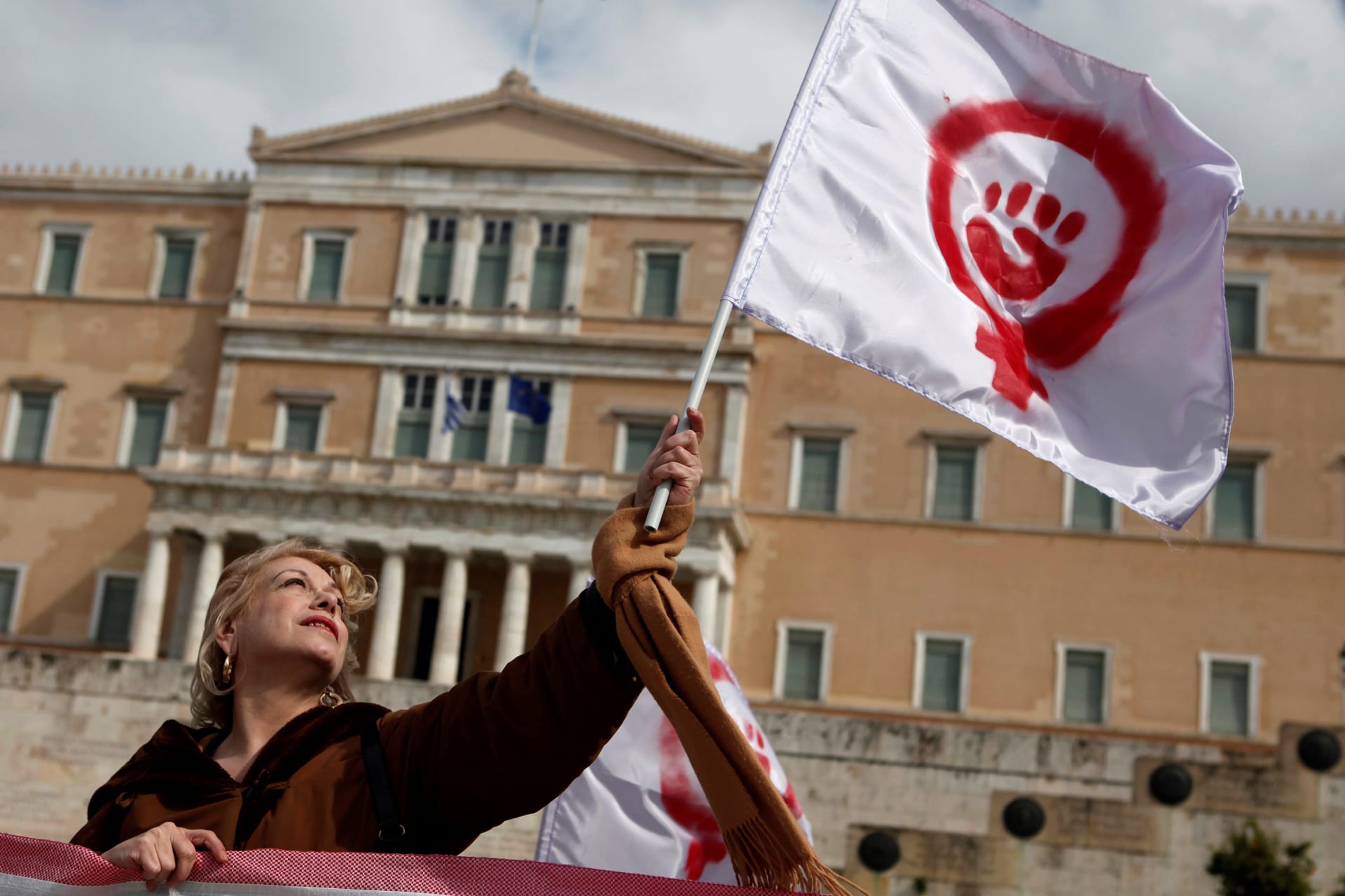 <p>A woman waves a flag depicting a symbol of feminism during a march to celebrate International Women’s Day in Athens March 8, 2014. </p>
