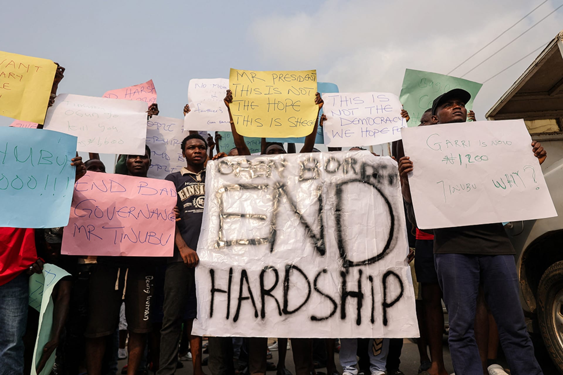 <p>Demonstrators hold placards during a protest against the hike in price and hard living conditions in Ibadan, Nigeria on February 19, 2024.</p>
