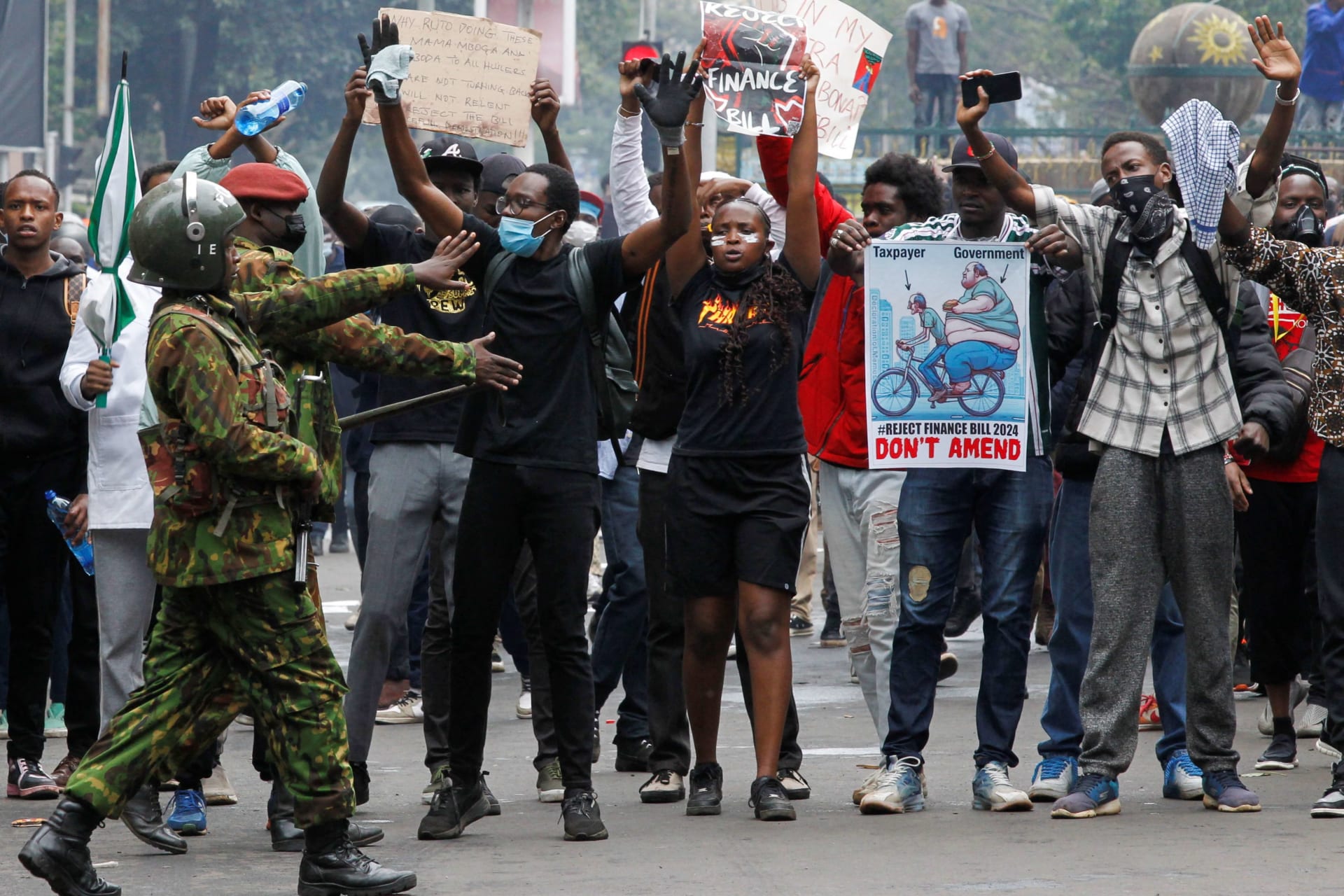 <p>Protesters react after police use teargas to disperse them during a demonstration against Kenya’s proposed finance bill in Nairobi, Kenya, on June 20, 2024.</p>

