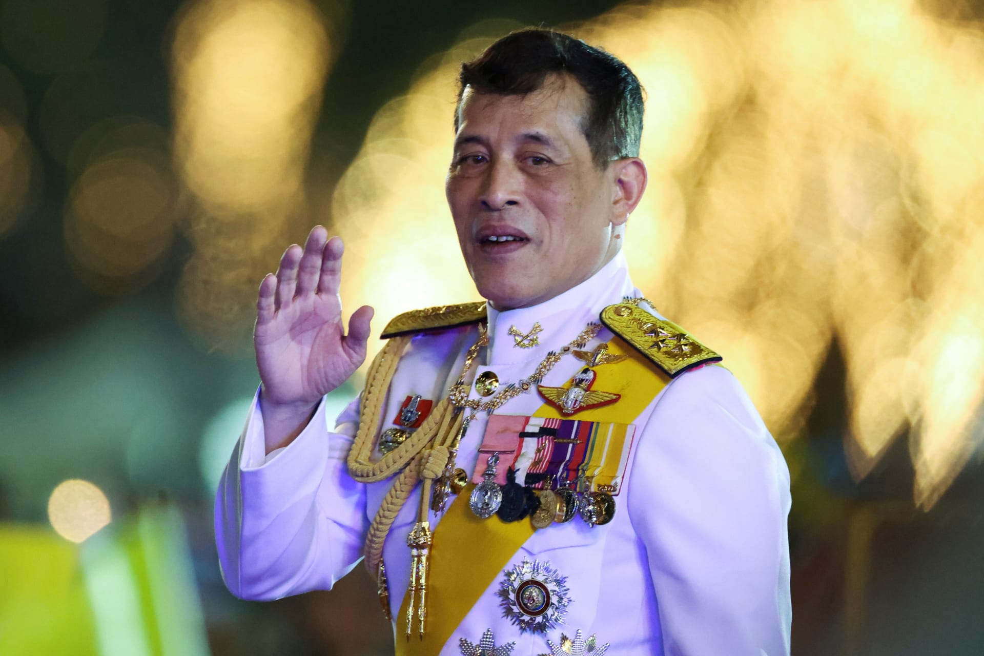 <p>Thailand’s King Maha Vajiralongkorn greets royalists at a candlelight vigil to remember the birthday of Thailand’s late King Bhumibol Adulyadej, outside the Grand Palace in Bangkok, Thailand, on December 5, 2020.</p>

