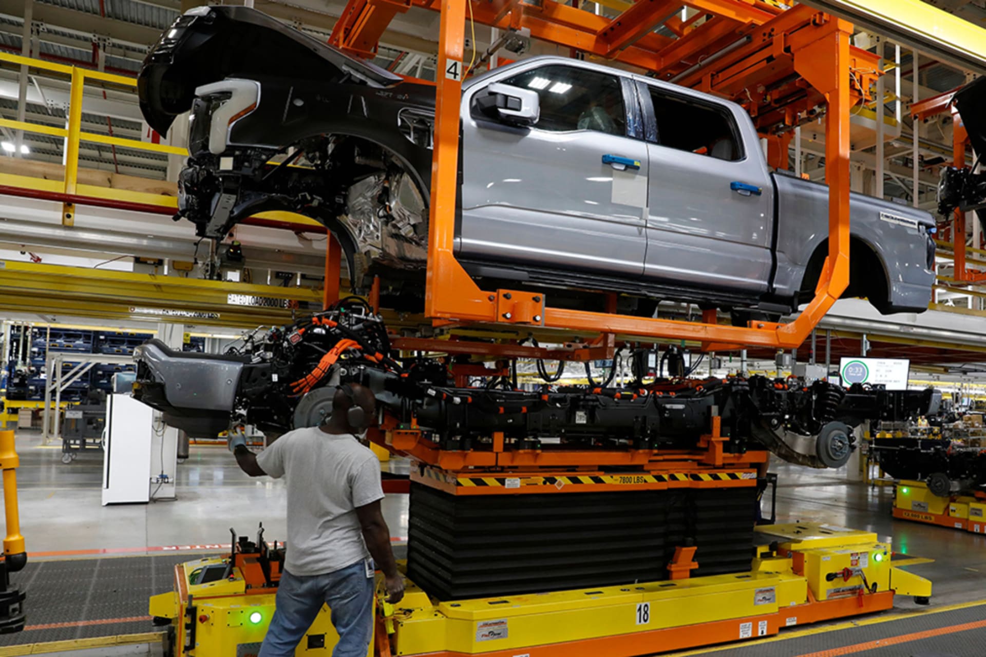 <p>The truck cab is lowered on the frame of Ford Motor Co. battery powered F-150 Lightning trucks under production at their Rouge Electric Vehicle Center in Dearborn, Michigan.</p>
